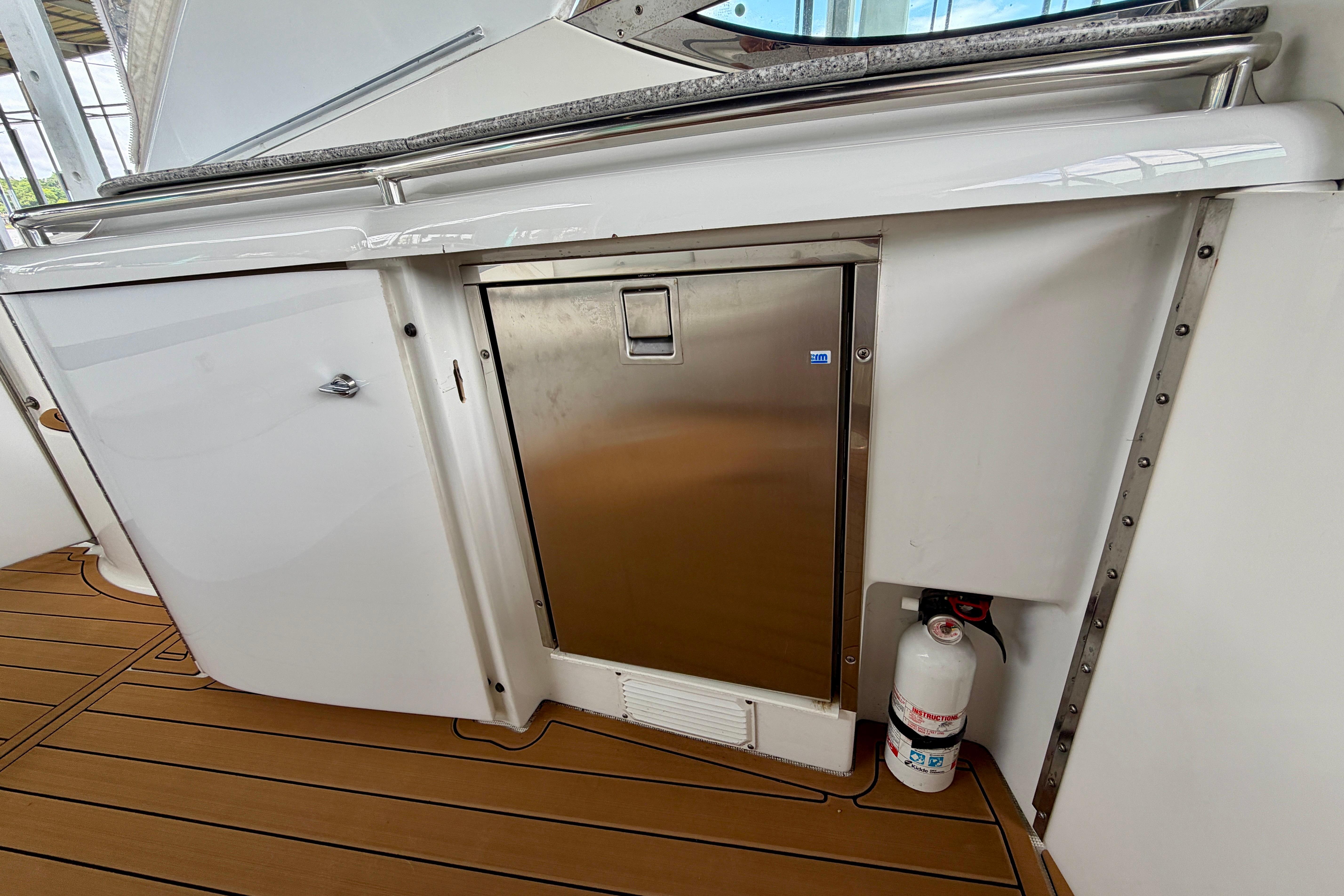 2006 Formula 400 Super Sport yacht interior with stainless steel fridge and fire extinguisher.