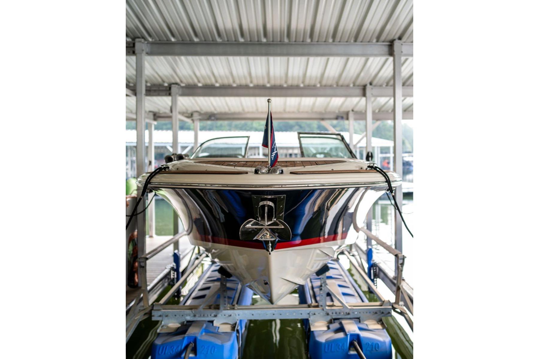2023 Chris-Craft Launch 27 boat docked in a covered marina.
