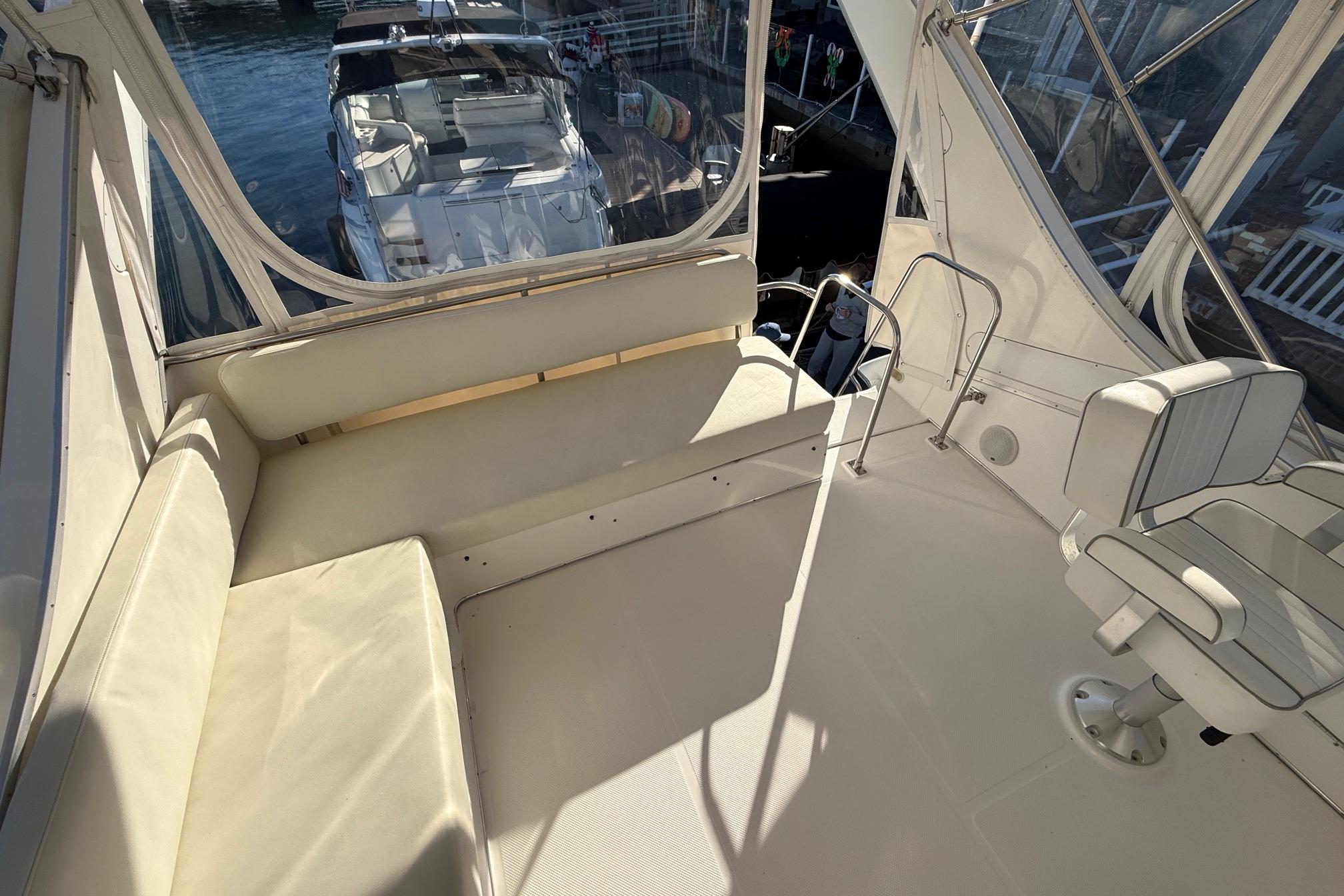 1995 Bayliner 39 Motoryacht interior with seating and helm, docked at marina.