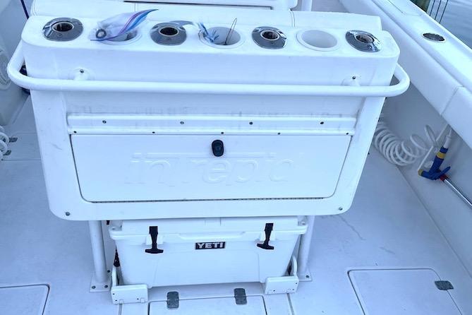 2002 Intrepid 323 Cuddy boat deck with fishing rod holders and Yeti cooler.