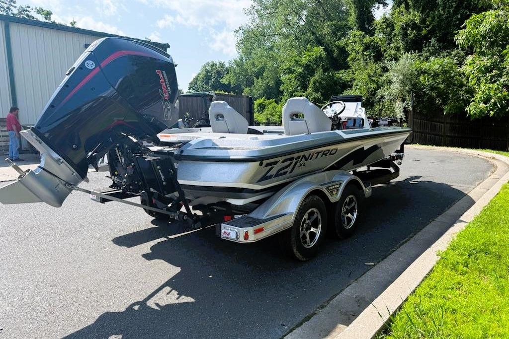 2025 Nitro Z21 XL Pro boat on trailer, parked outdoors, with powerful outboard motor.