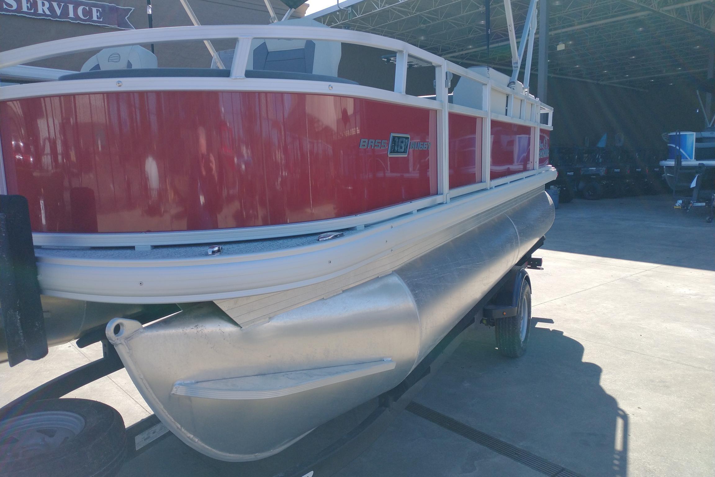 2026 Sun Tracker Bass Buggy 18 DLX pontoon boat in a service area.