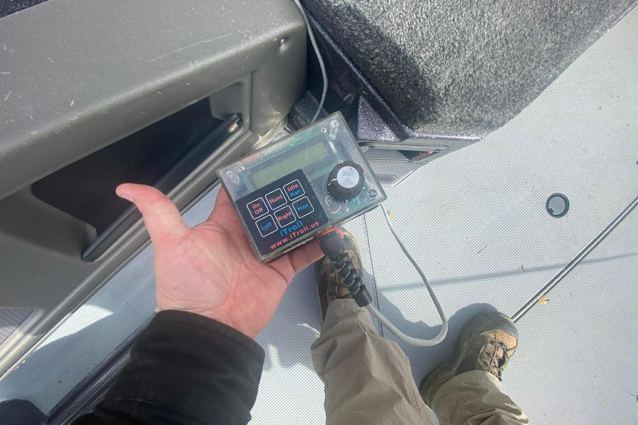 Hand holding a control device on a 2017 Ranger 621FS Fisherman boat deck.