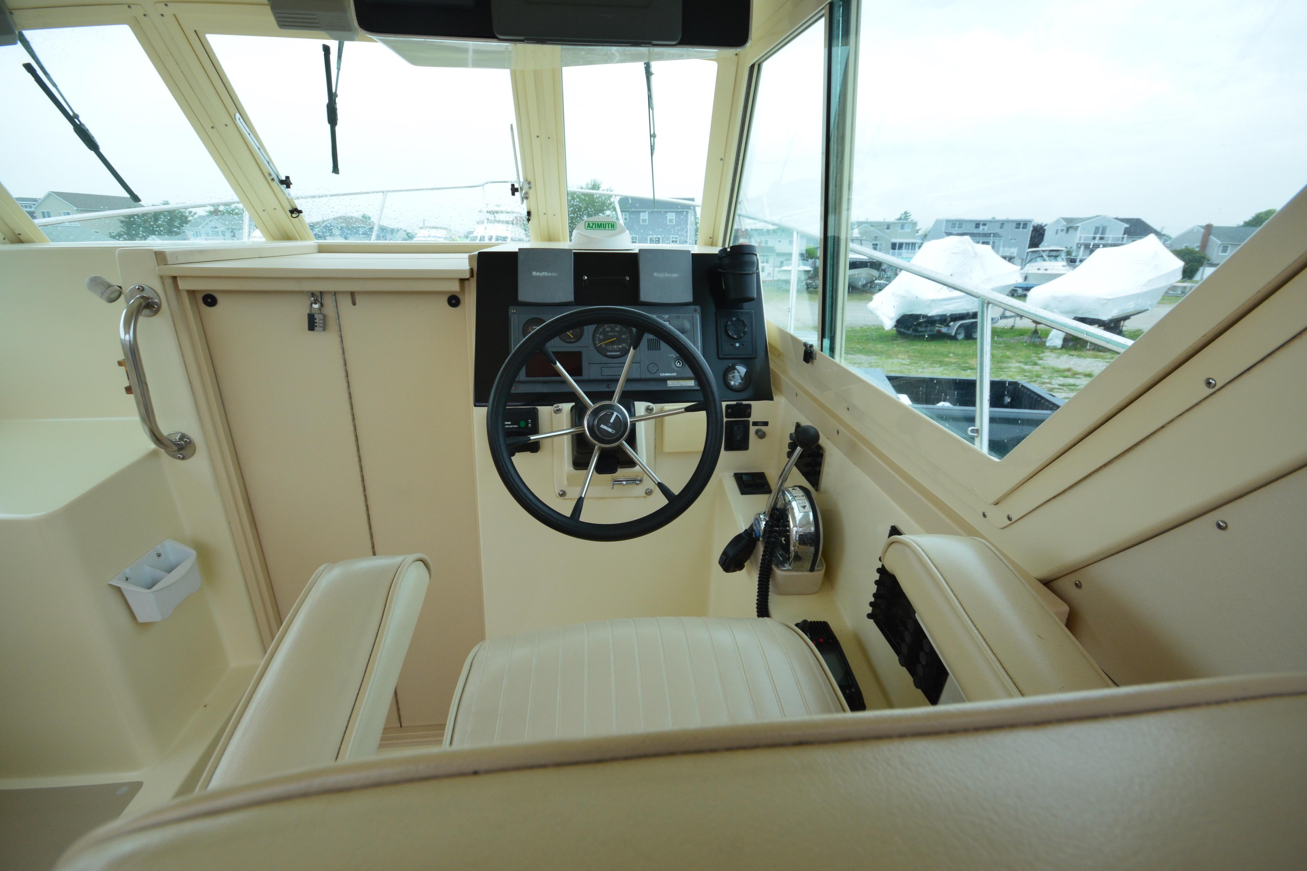 Interior view of 2001 Albin 28 Tournament Express boat cockpit with steering wheel and controls.