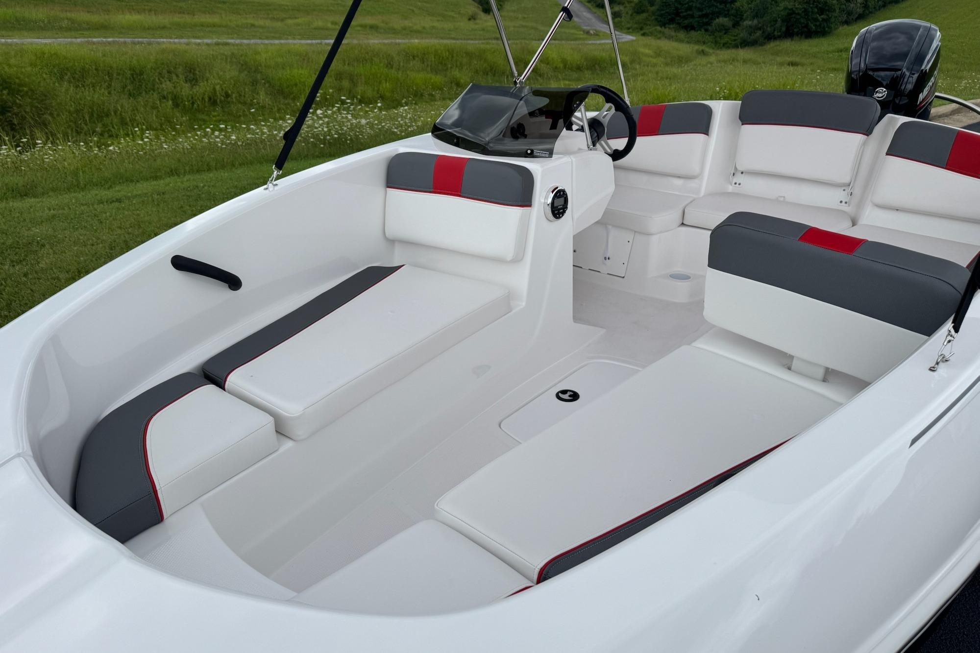 2026 Tahoe T16 boat interior with white and gray seating, red accents, and steering console.