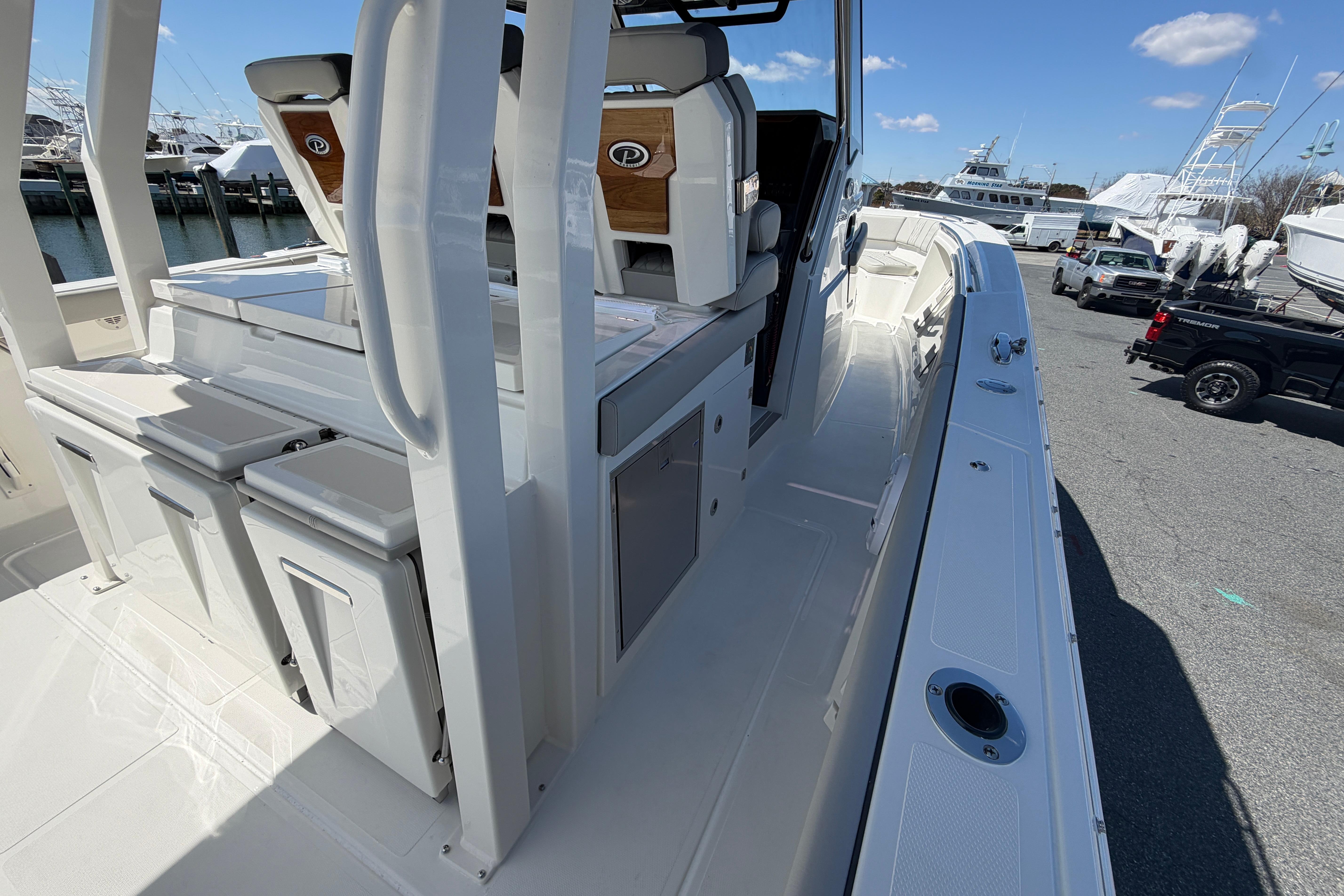 2026 Pursuit S 358 Sport boat interior with seating and storage, docked at marina.
