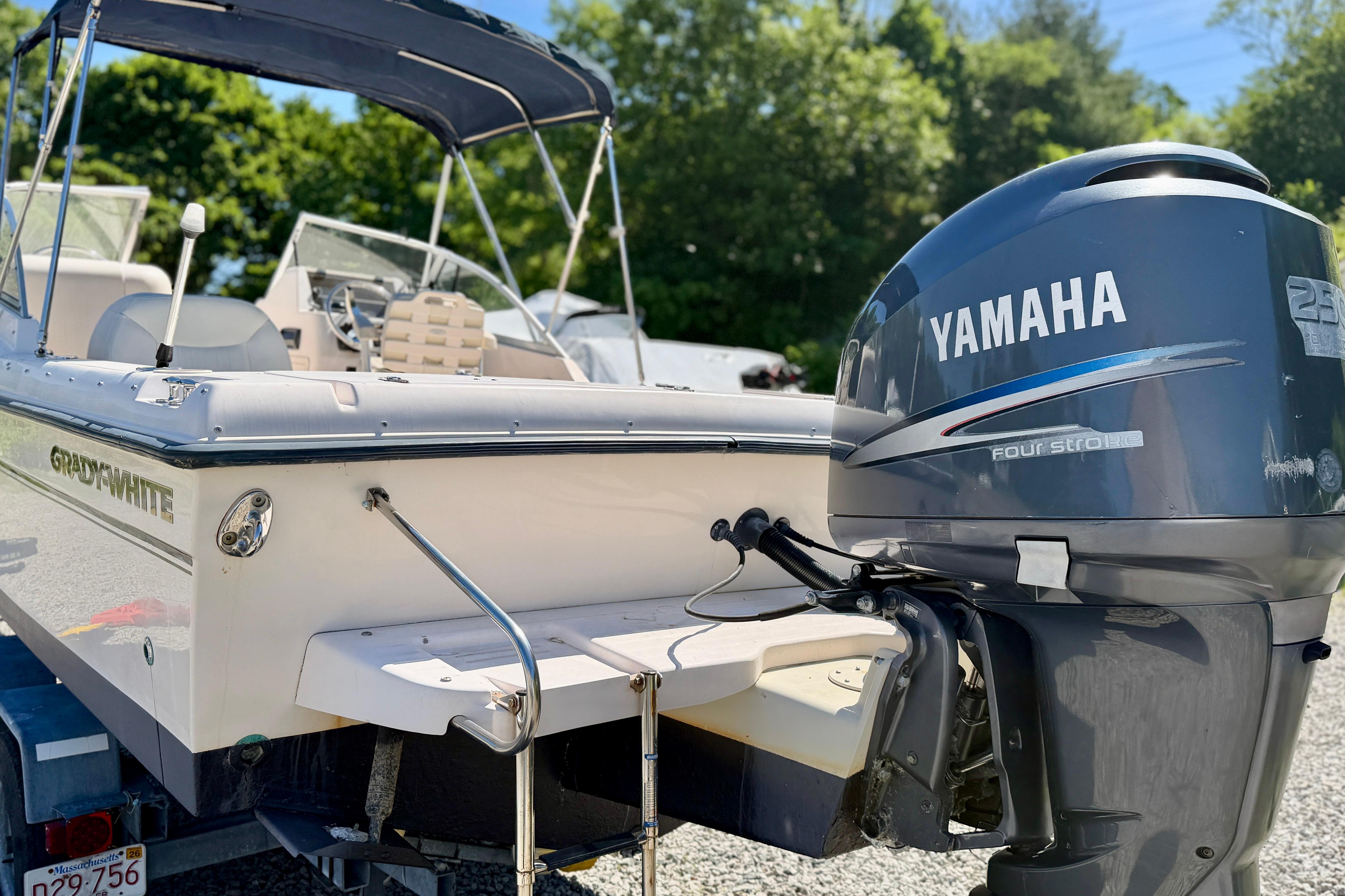 2005 Grady-White Freedom 225 boat with Yamaha outboard motor, parked outdoors.
