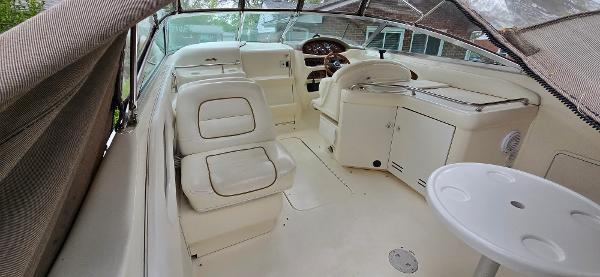 1999 Sea Ray 280 SS boat interior with white seating and helm area.