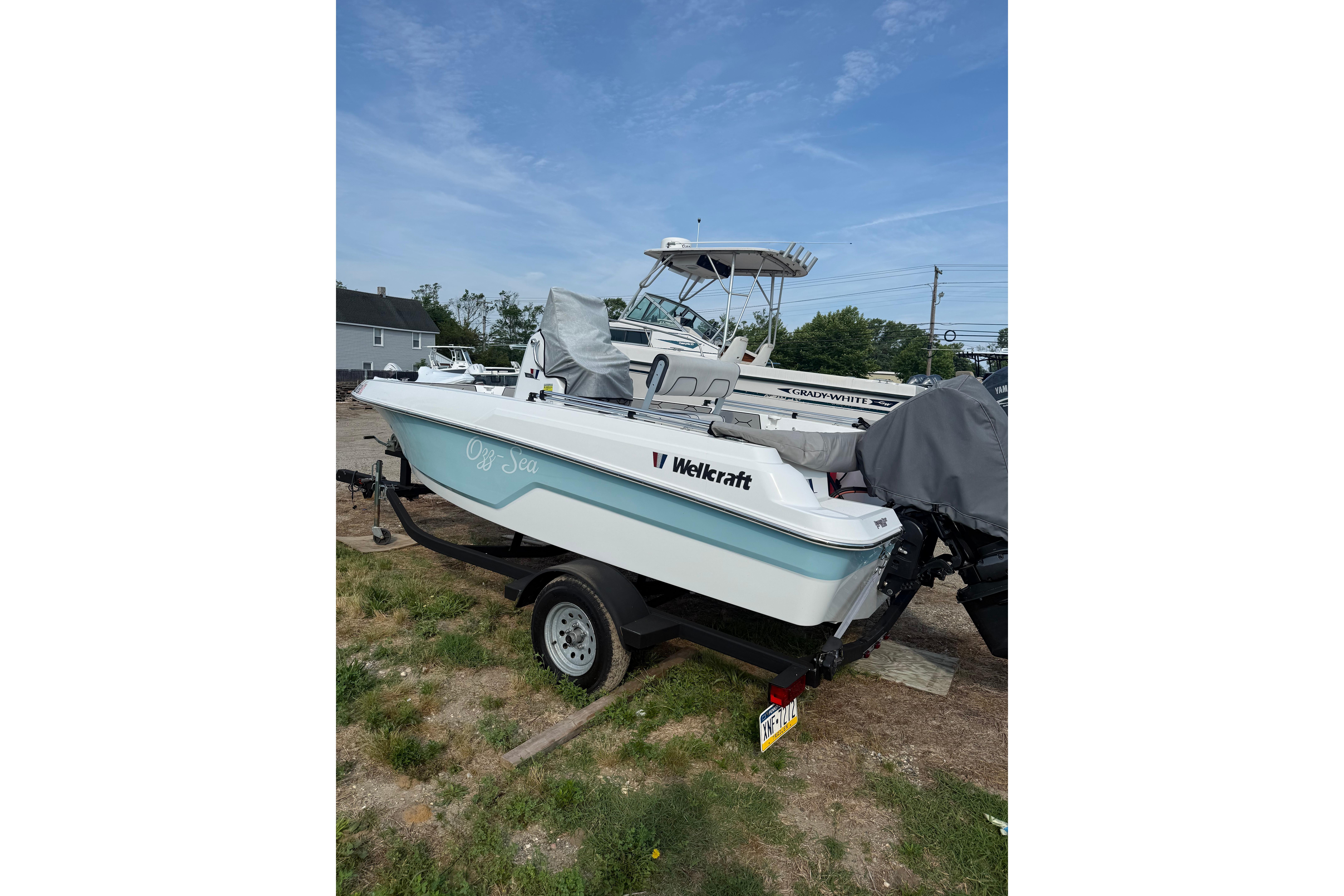 2020 Wellcraft 162 Fisherman boat on trailer, parked outdoors under blue sky.