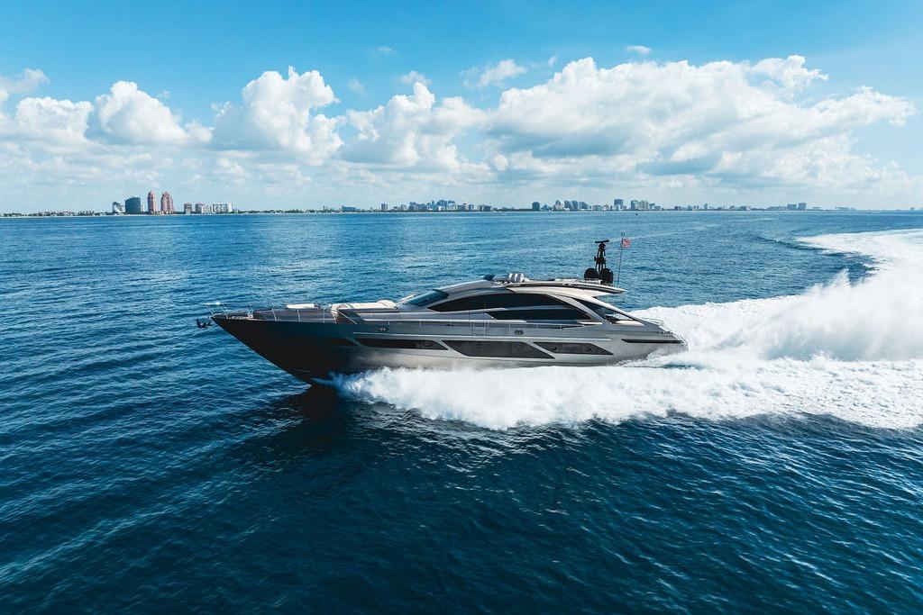 2019 Pershing 9X yacht cruising on open sea under a clear blue sky.