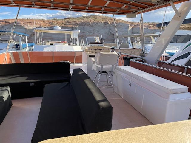 Top deck of 2007 American Waterways Houseboat Sundancer Trip #17 with seating and helm.