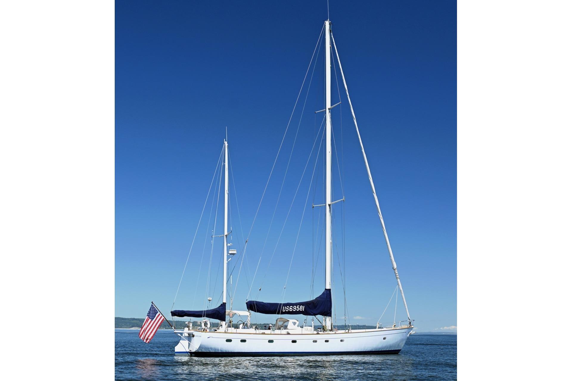 Sailing yacht Abeking & Rasmussen Tripp 74, 1968 model, on calm waters under clear blue sky.