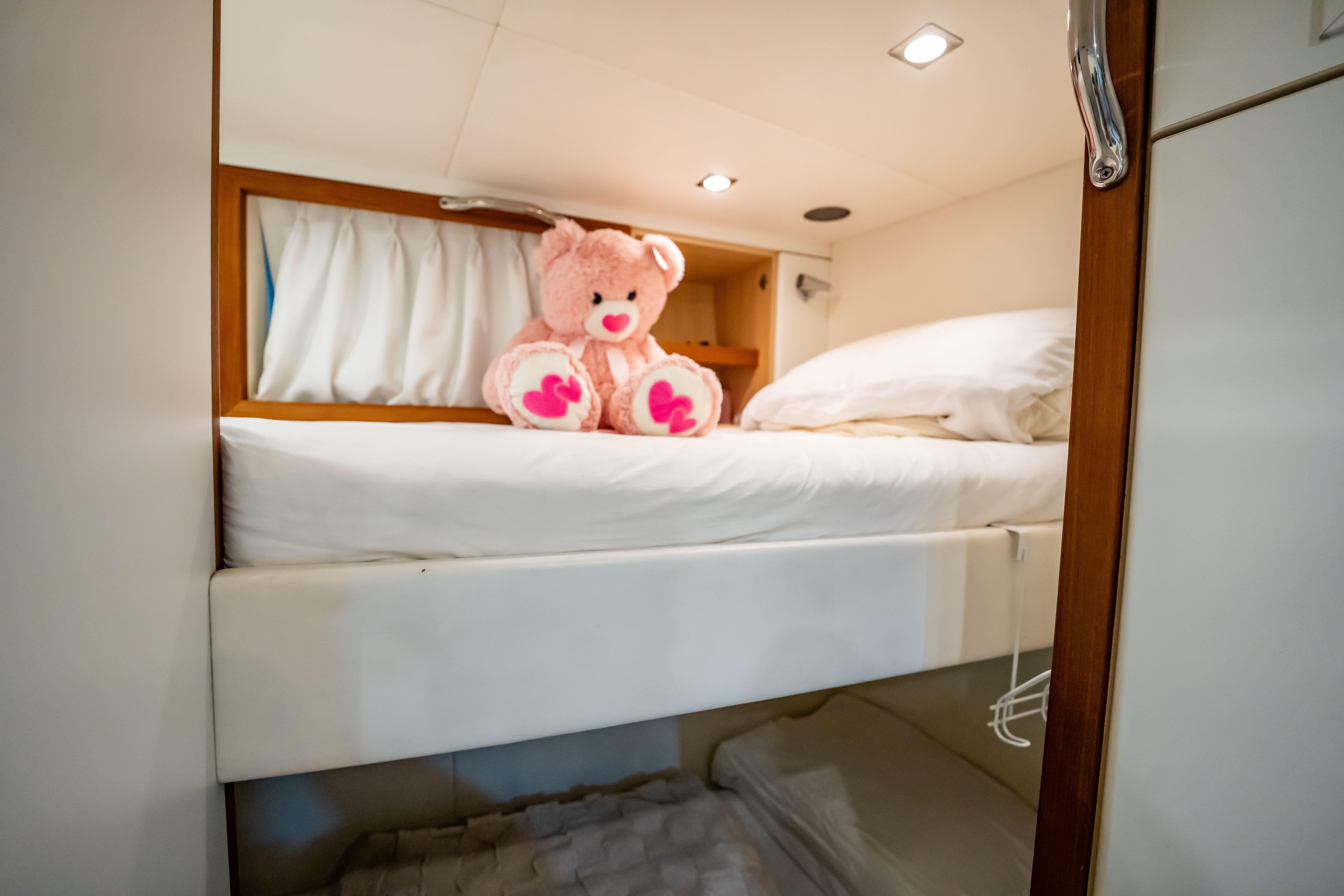 Cozy yacht cabin with bunk beds and a pink teddy bear, Sunseeker 34 Metre Yacht, 2011.