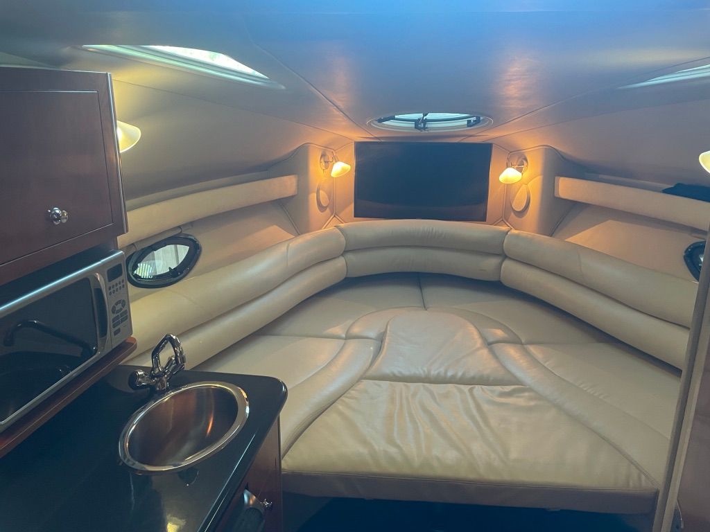 Interior of the 2007 Doral Monticello with beige leather, portholes, and a small kitchenette.