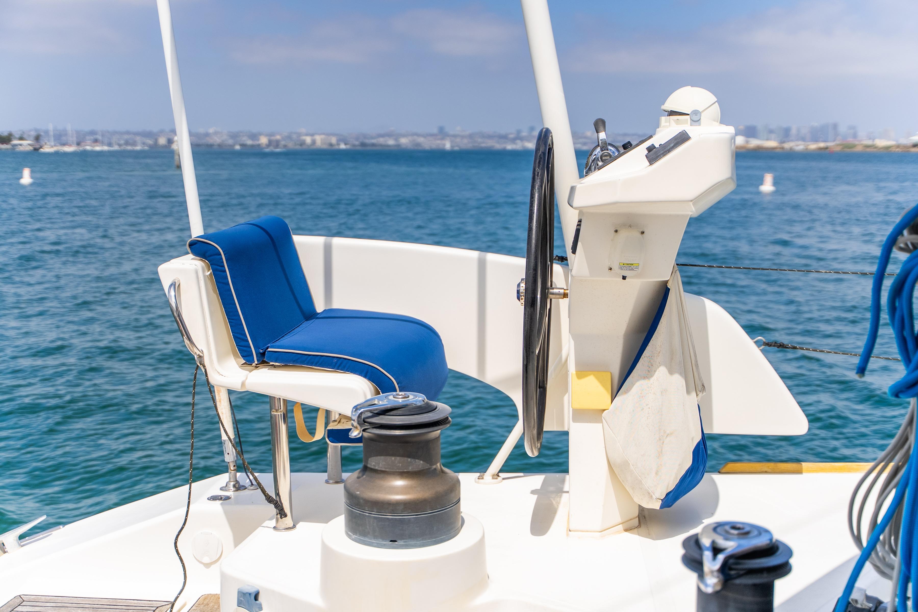 Helm of 2009 Catana 65 yacht with blue seating, overlooking ocean.