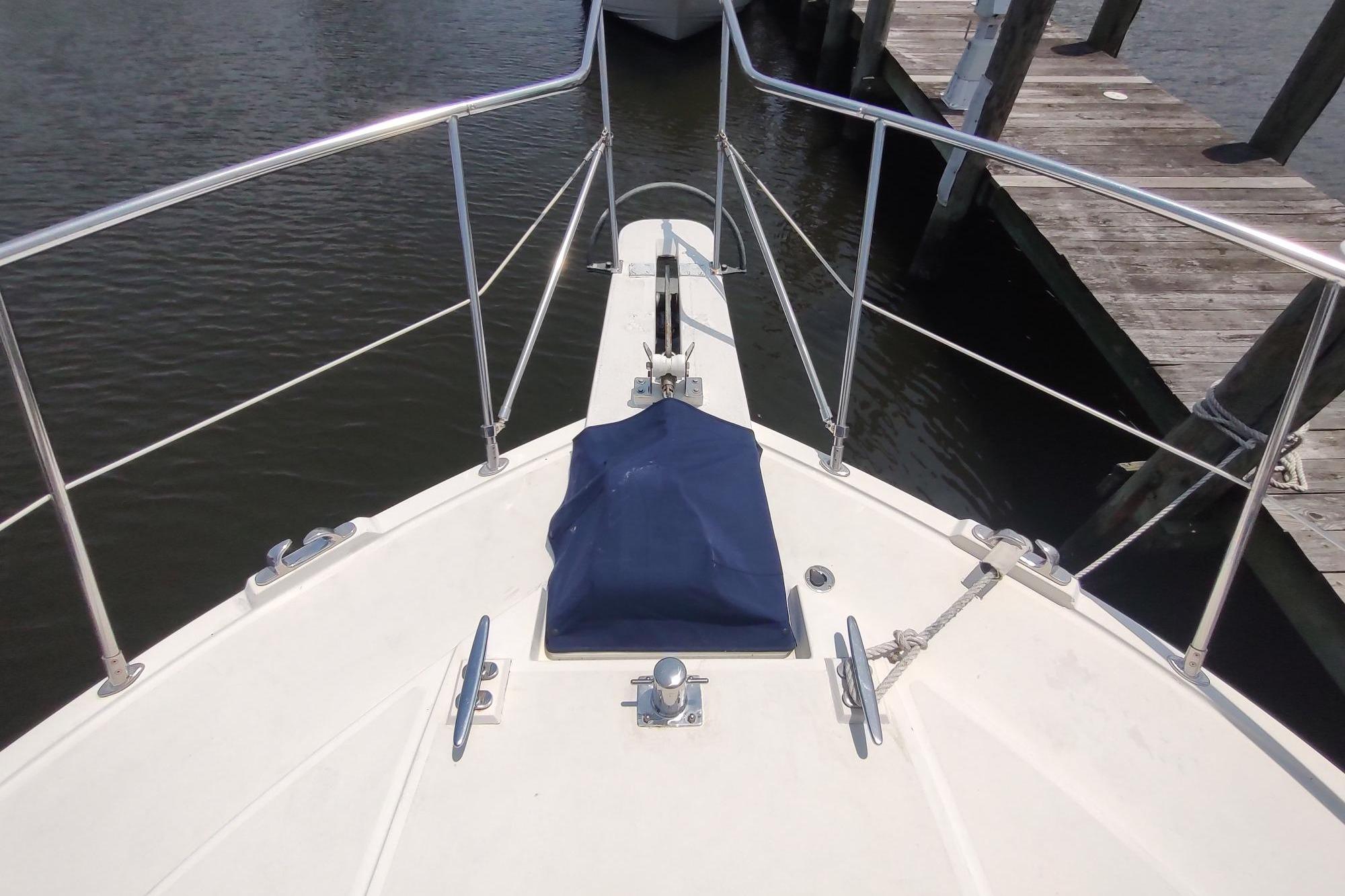 Bow view of 1989 Hyatt Double Cabin Motoryacht docked at marina.