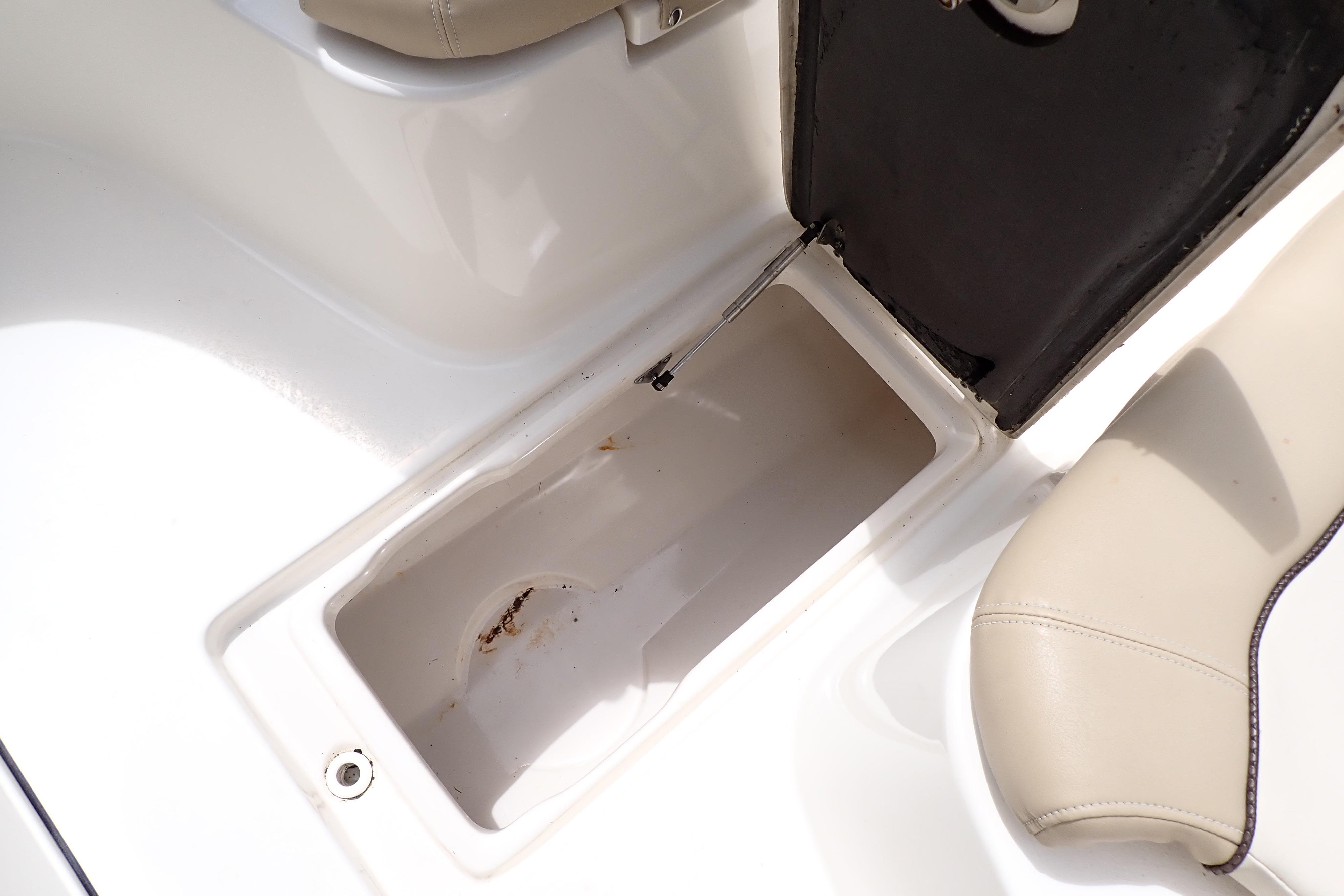 Open storage compartment in 2019 Key West 263 FS boat, featuring beige seating.