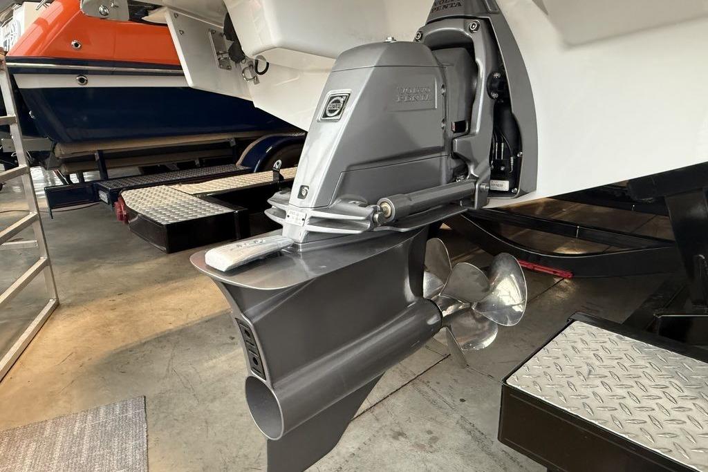 2026 Cobalt R4 Surf boat with advanced propulsion system in a showroom.