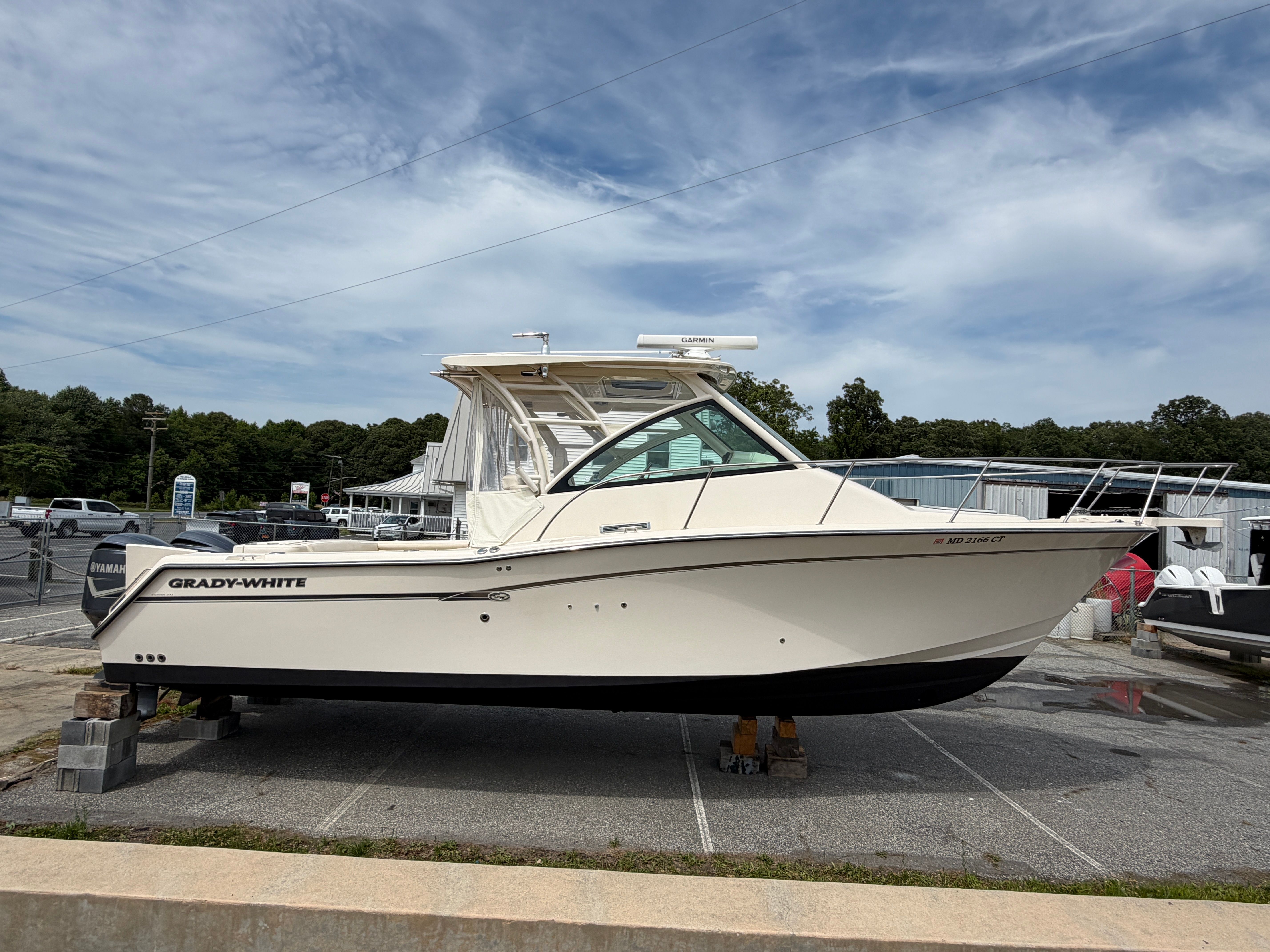 A Grady-White Express 330 boat is parked on a lot.