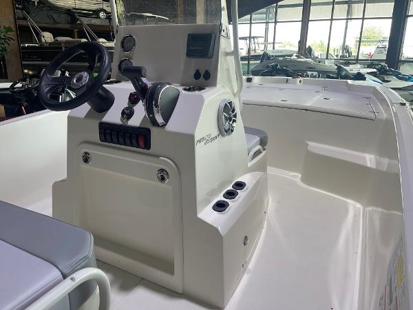 2024 Mako Pro Skiff 19 CC center console boat interior with steering wheel and controls.