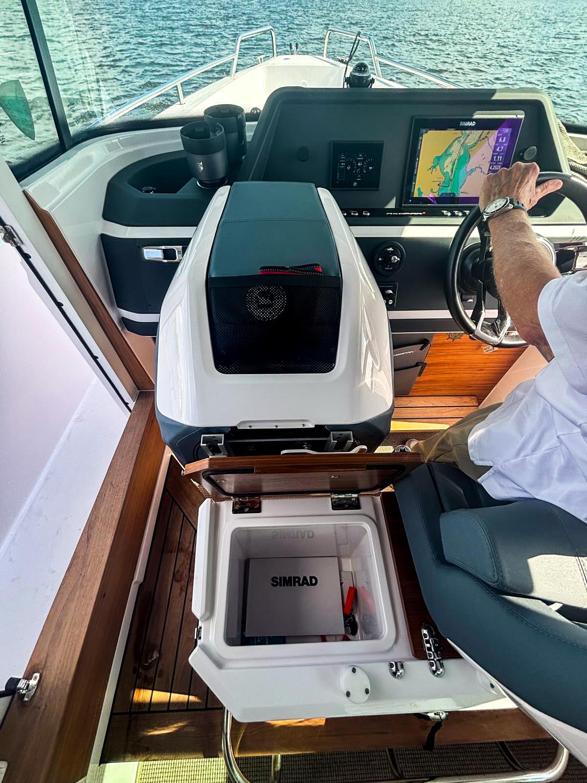 2022 Axopar 28 CABIN interior with navigation system and Simrad equipment on open water.