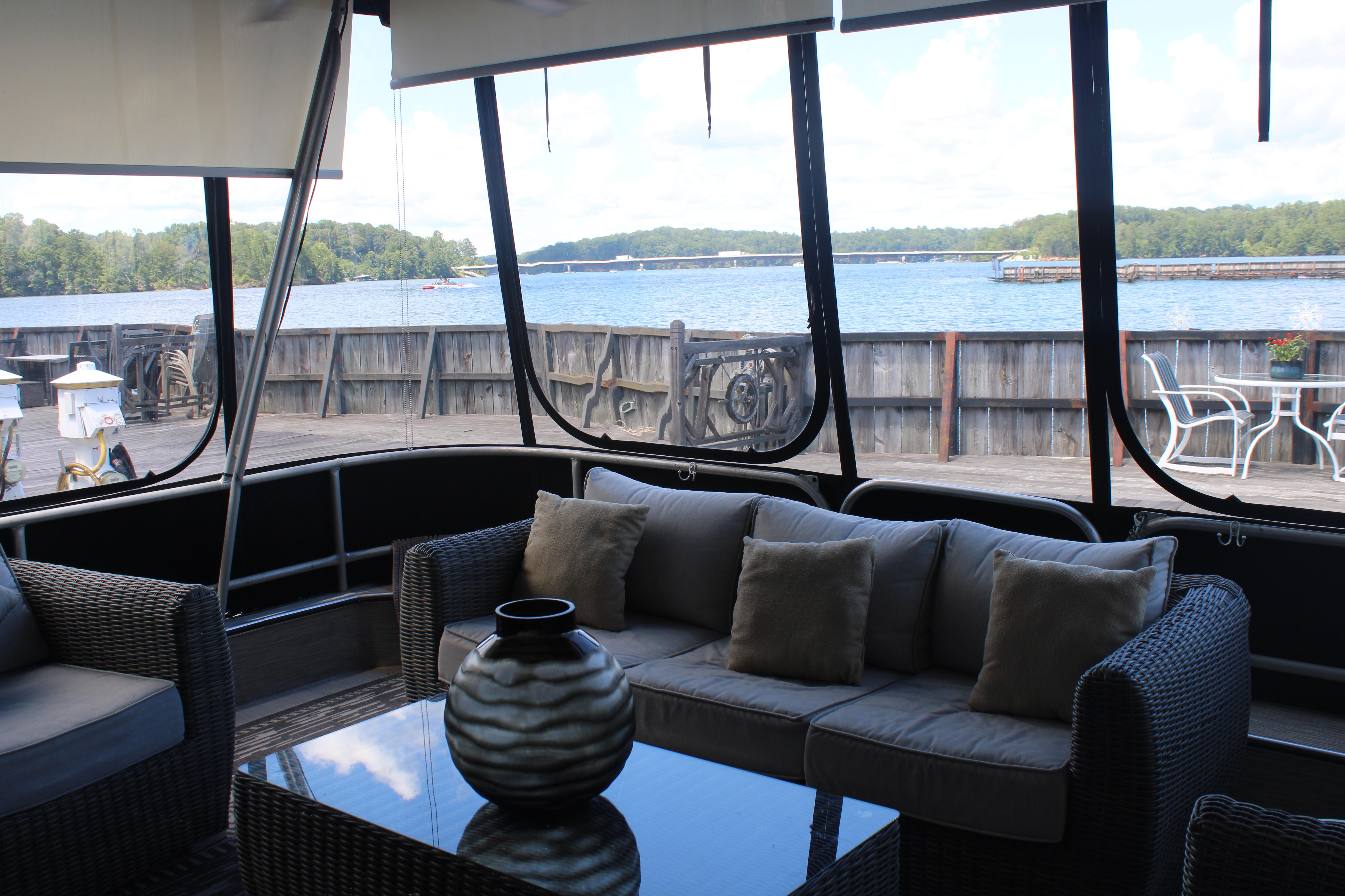 Interior view of a 1992 Sumerset 66 houseboat with lakefront seating area.