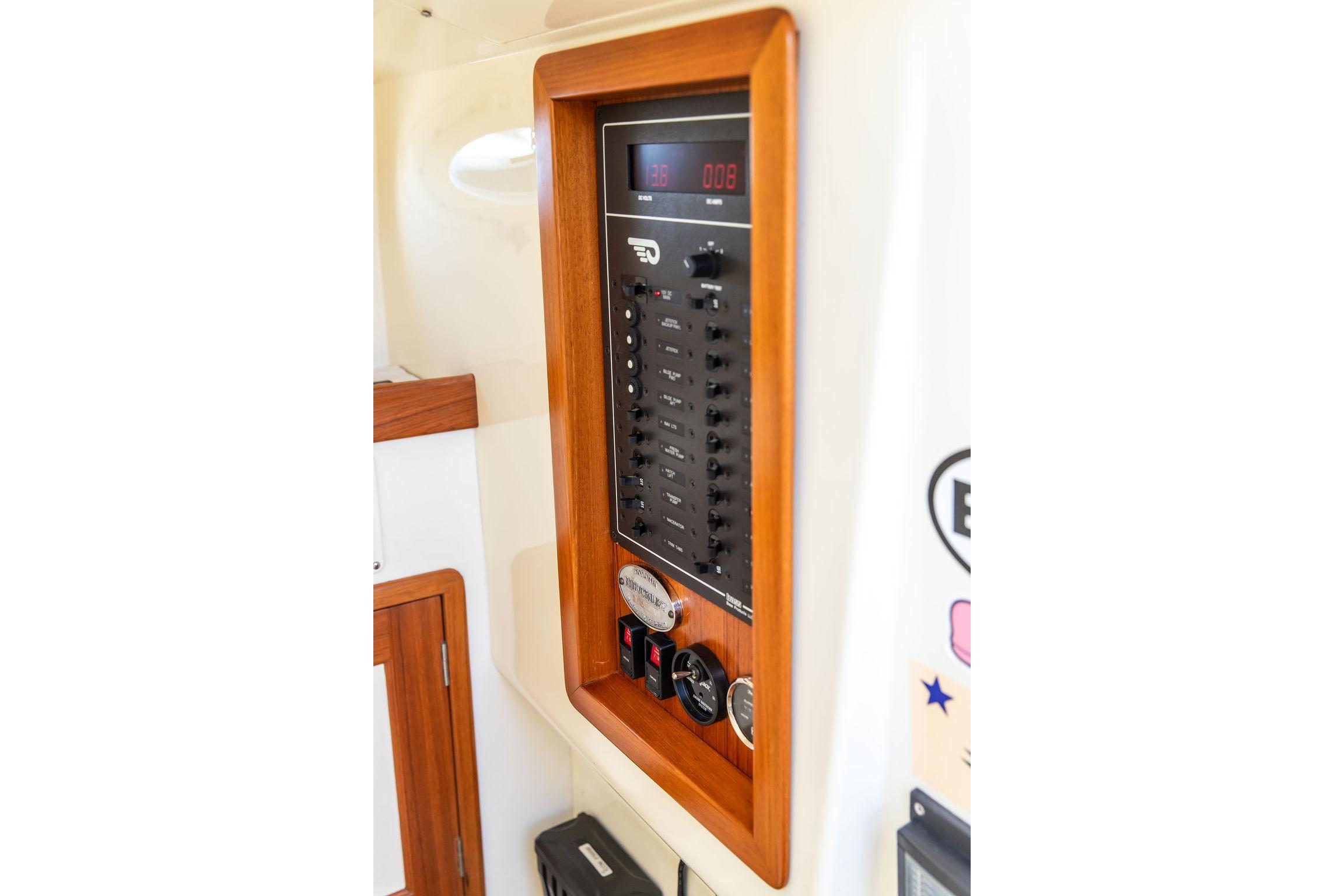 Control panel of a 2002 Hinckley Talaria 29C boat, featuring switches and gauges.