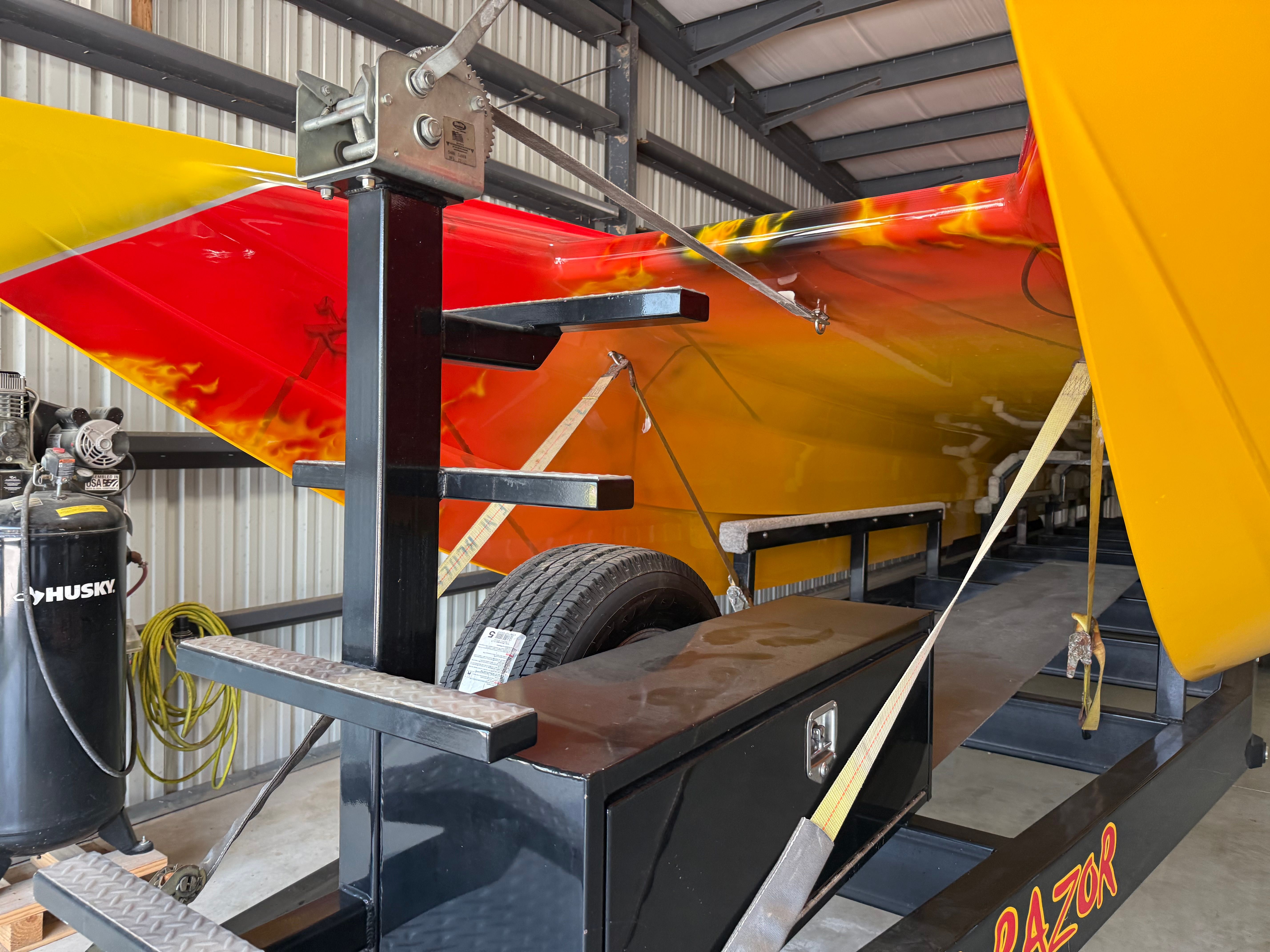 A 2010 MTI CAT secured on a trailer in a storage facility.