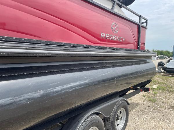 2023 Regency 250DL3 pontoon boat on trailer, featuring red and black design.