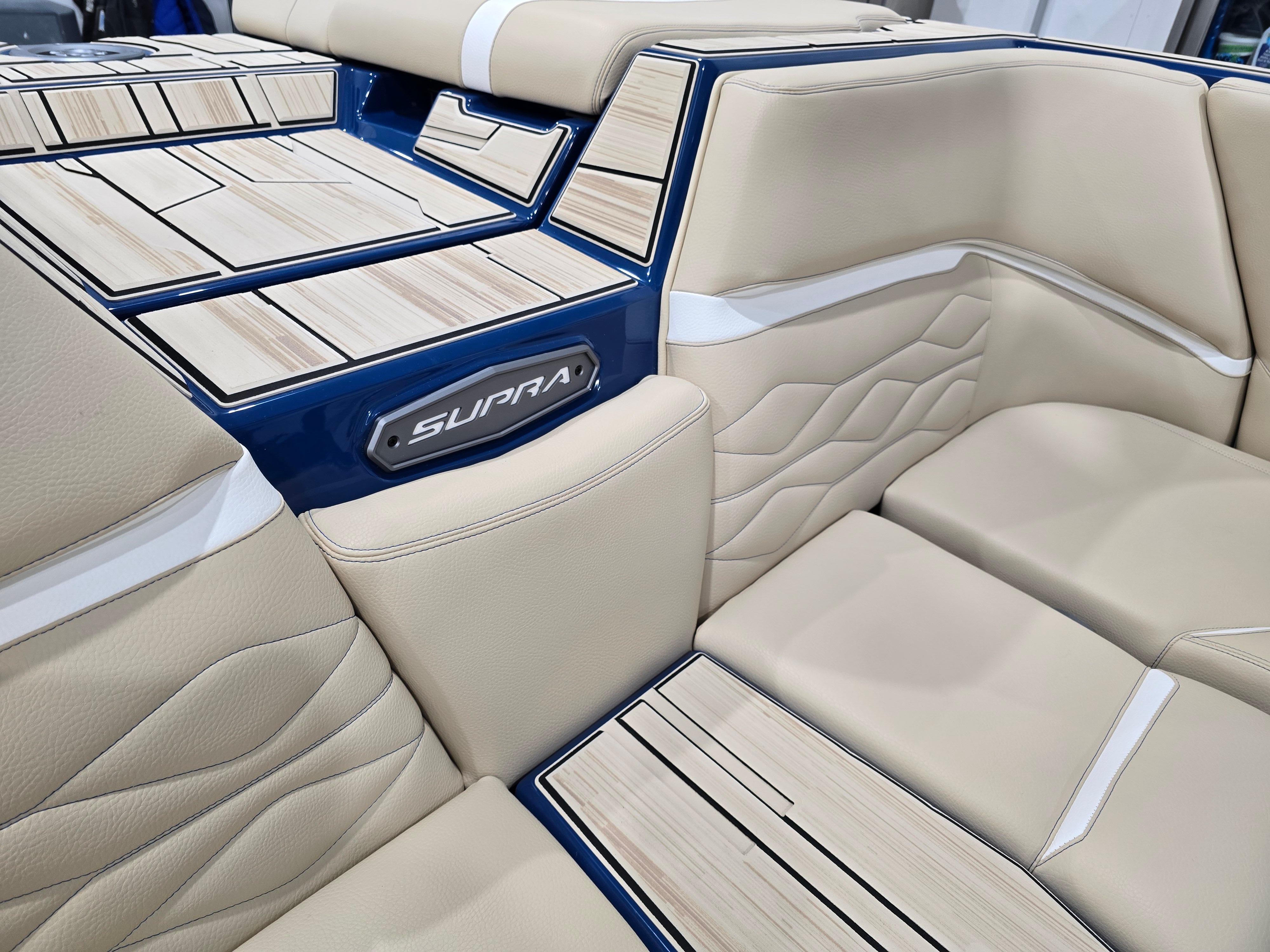2025 Supra SV interior with beige leather seats and wood accents.