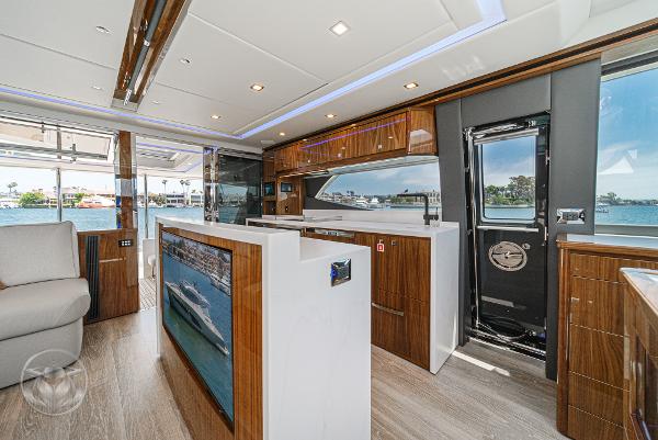 Luxurious interior of the 2025 Riviera 645 SUV yacht with modern design and waterfront view.