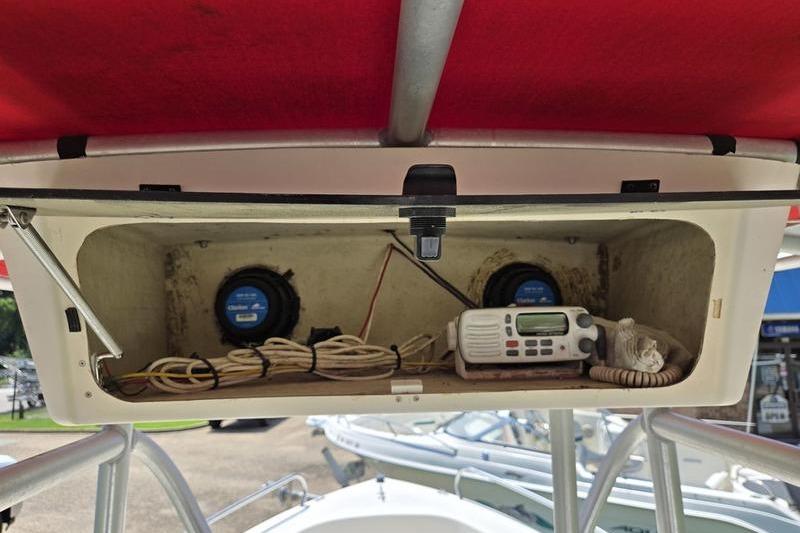 Storage compartment on a 2000 May-Craft 2000CC boat with radio and wiring.