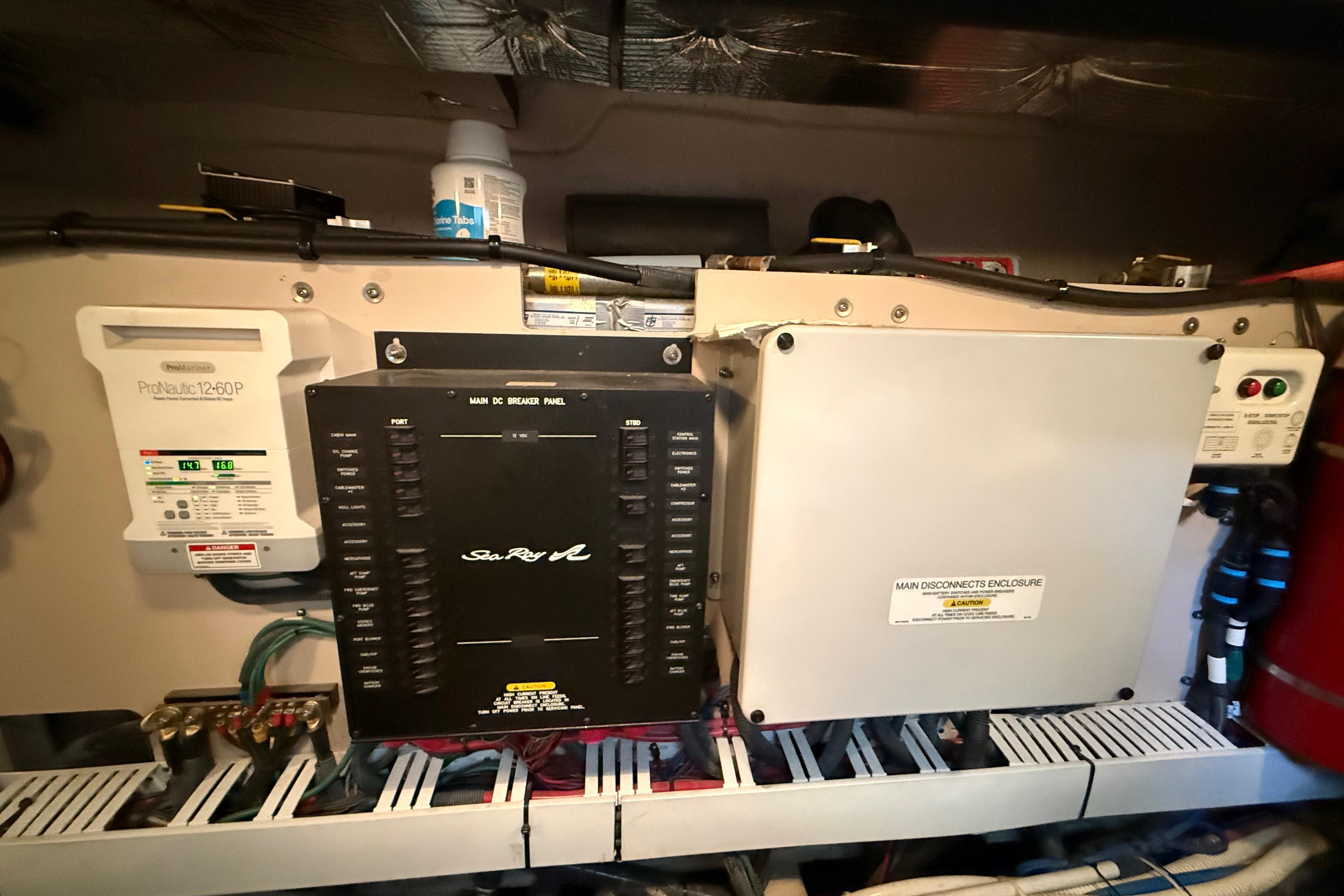 Electrical panel of 2016 Sea Ray Sundancer 510 yacht, featuring ProNautic charger and main disconnects.
