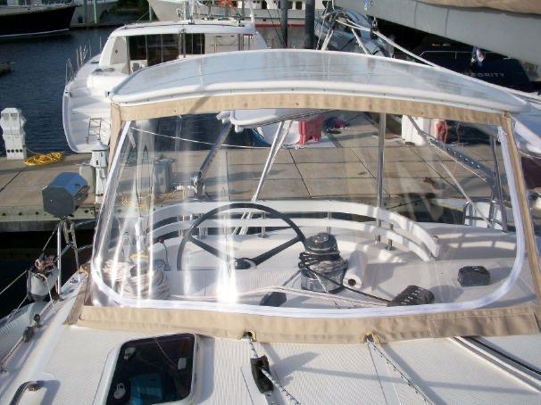 2009 Prout 45S yacht cockpit with clear canopy and steering wheel at marina.