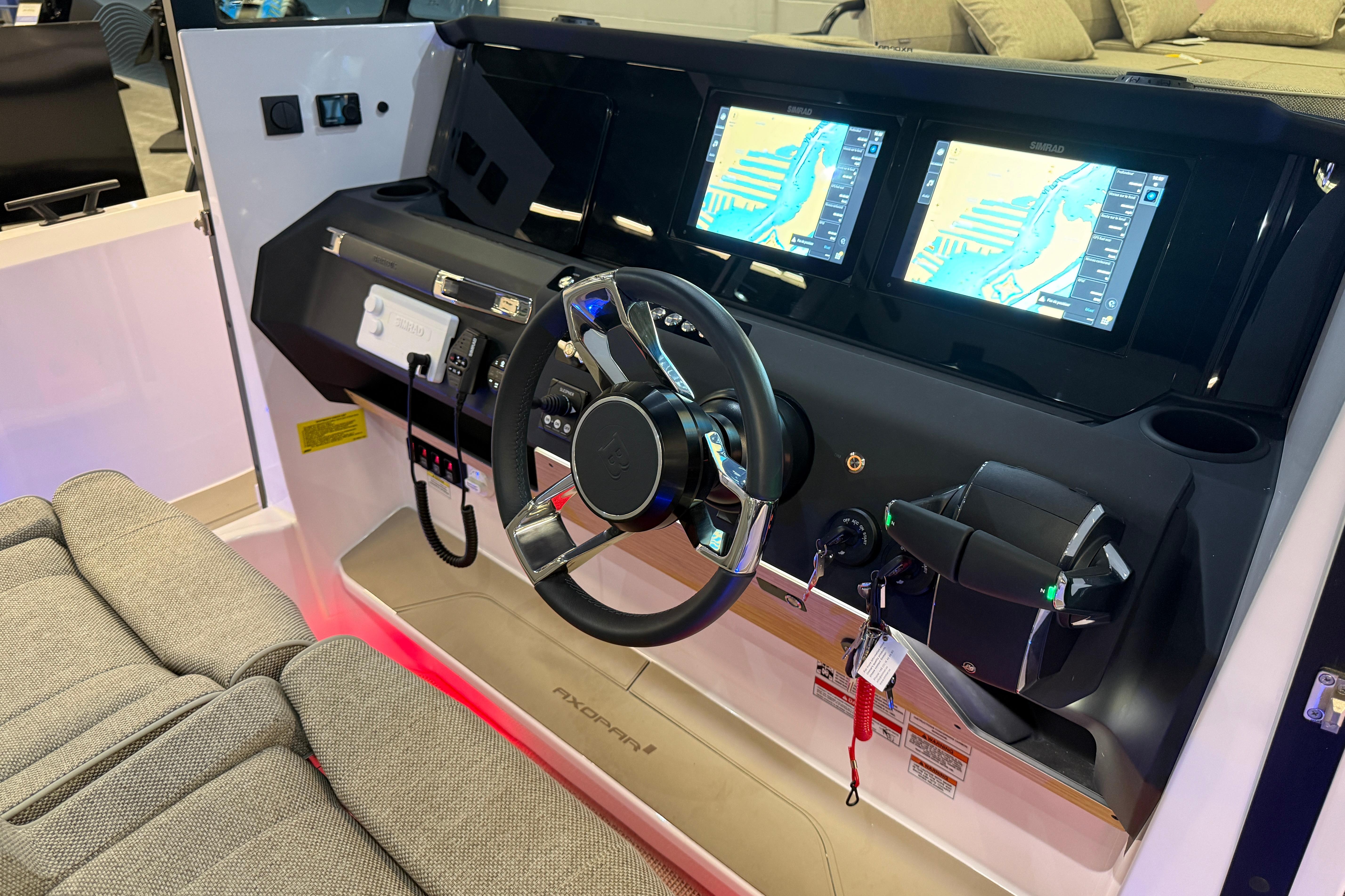 Interior cockpit of 2026 Axopar 29 XC Cross Cabin with dual navigation screens.
