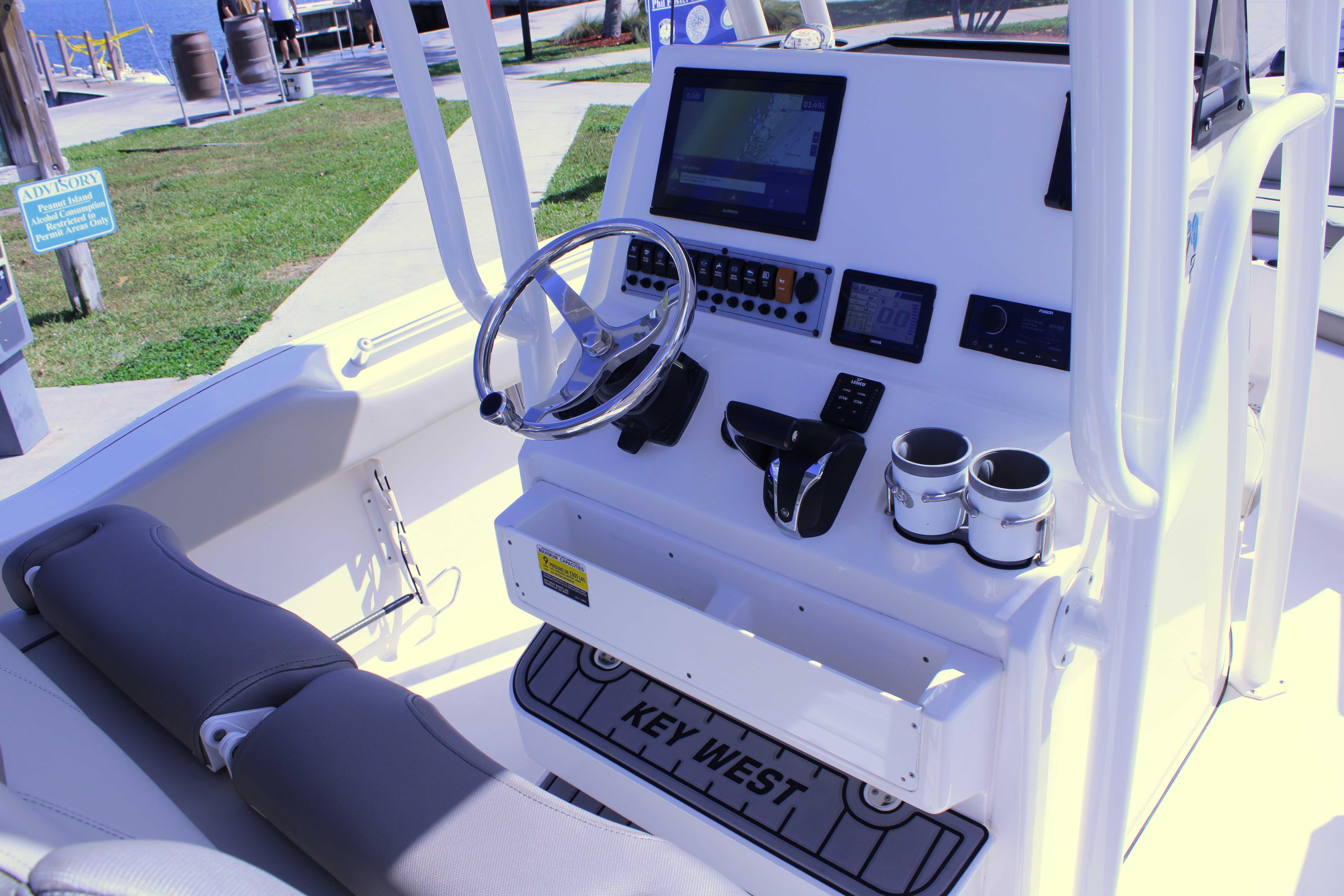 2021 Key West 239 FS boat cockpit with steering wheel and navigation controls.