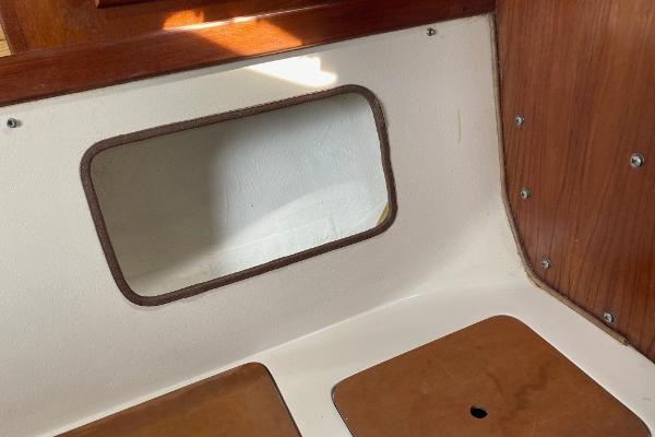 Interior view of a 1989 Catalina 30 sailboat with wooden and white paneling.