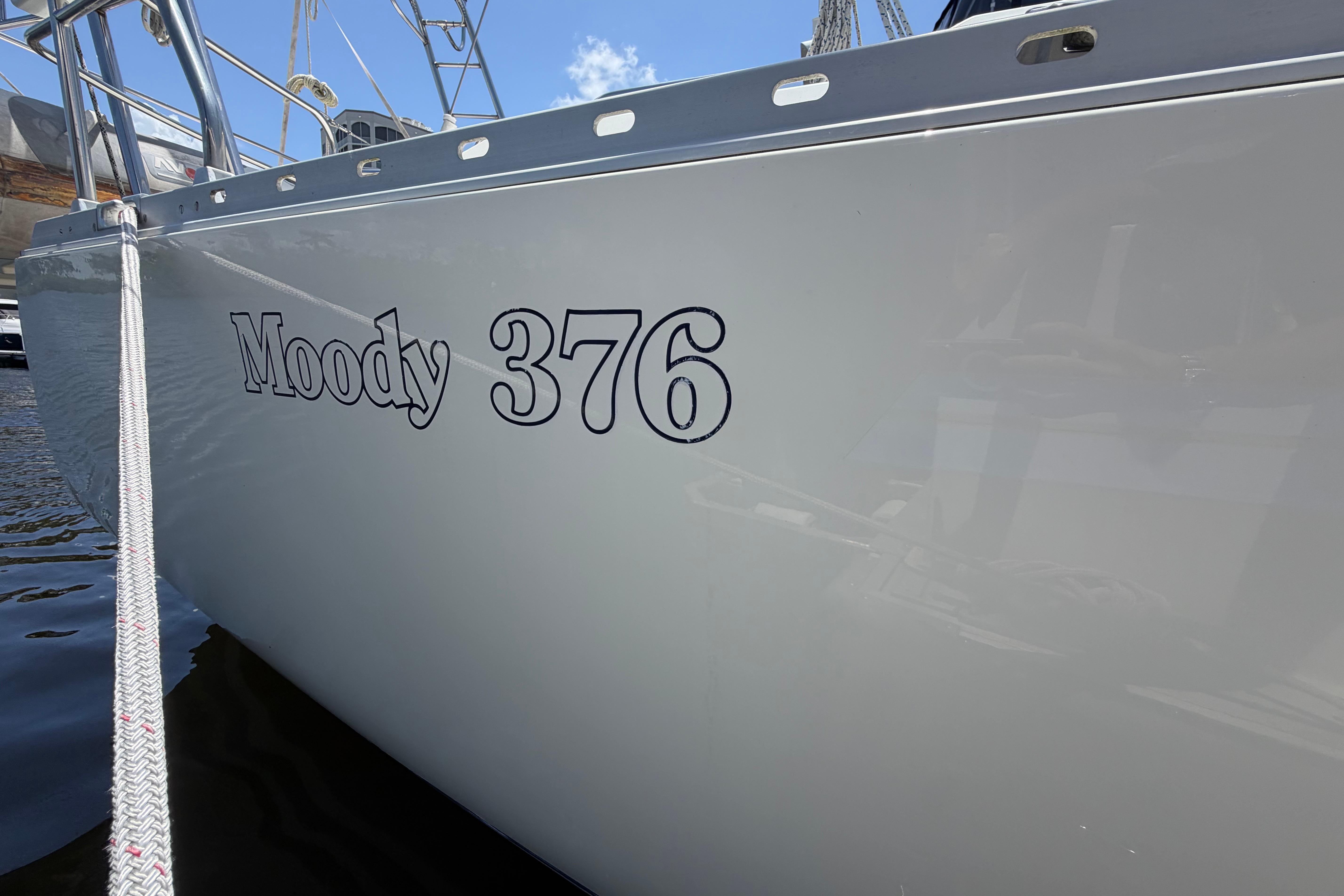 1987 Moody 376 sailboat docked, showcasing sleek design and clear branding.