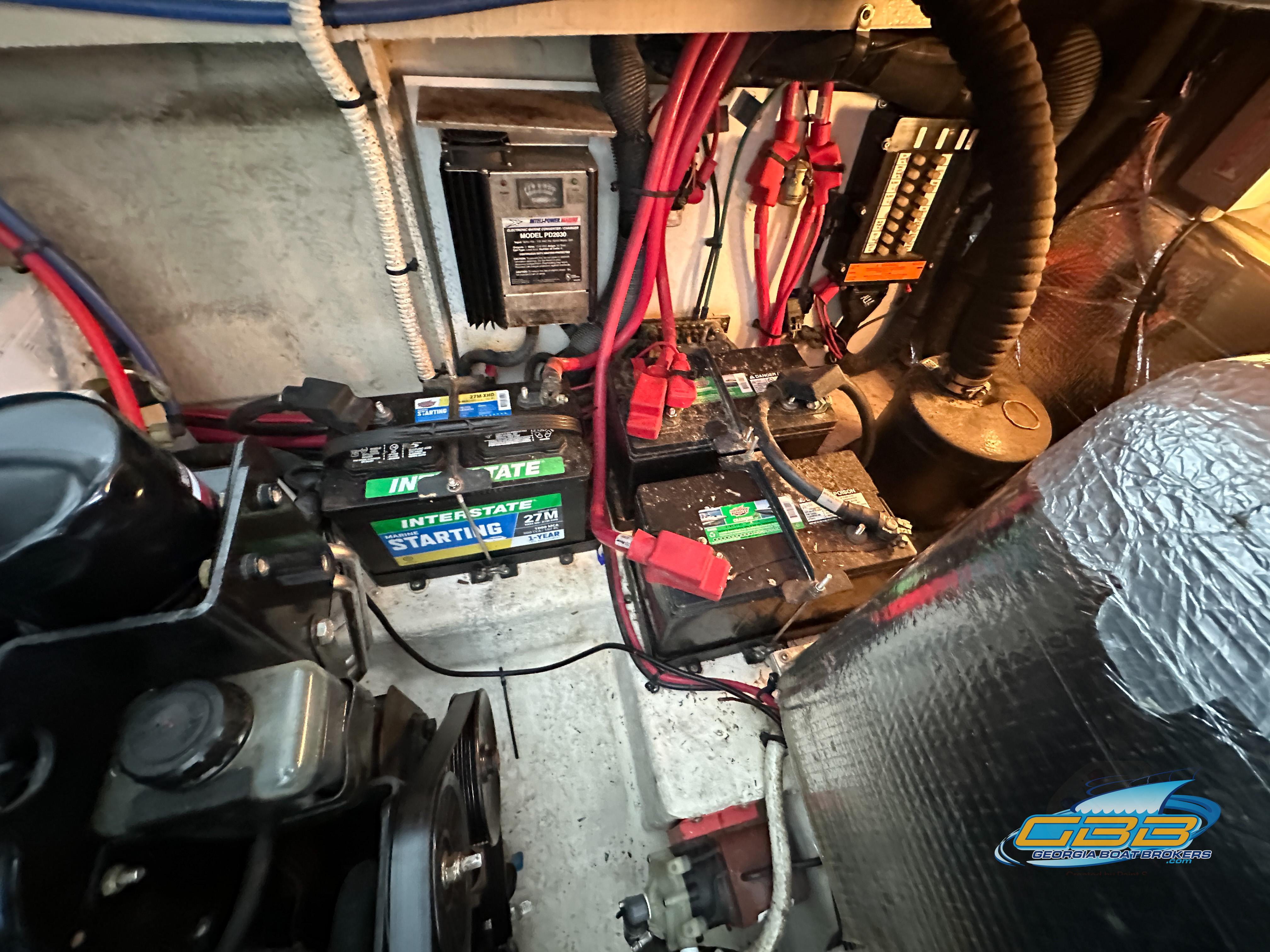 Engine compartment of a 2006 Sea Ray 290 Sundancer with batteries and wiring.