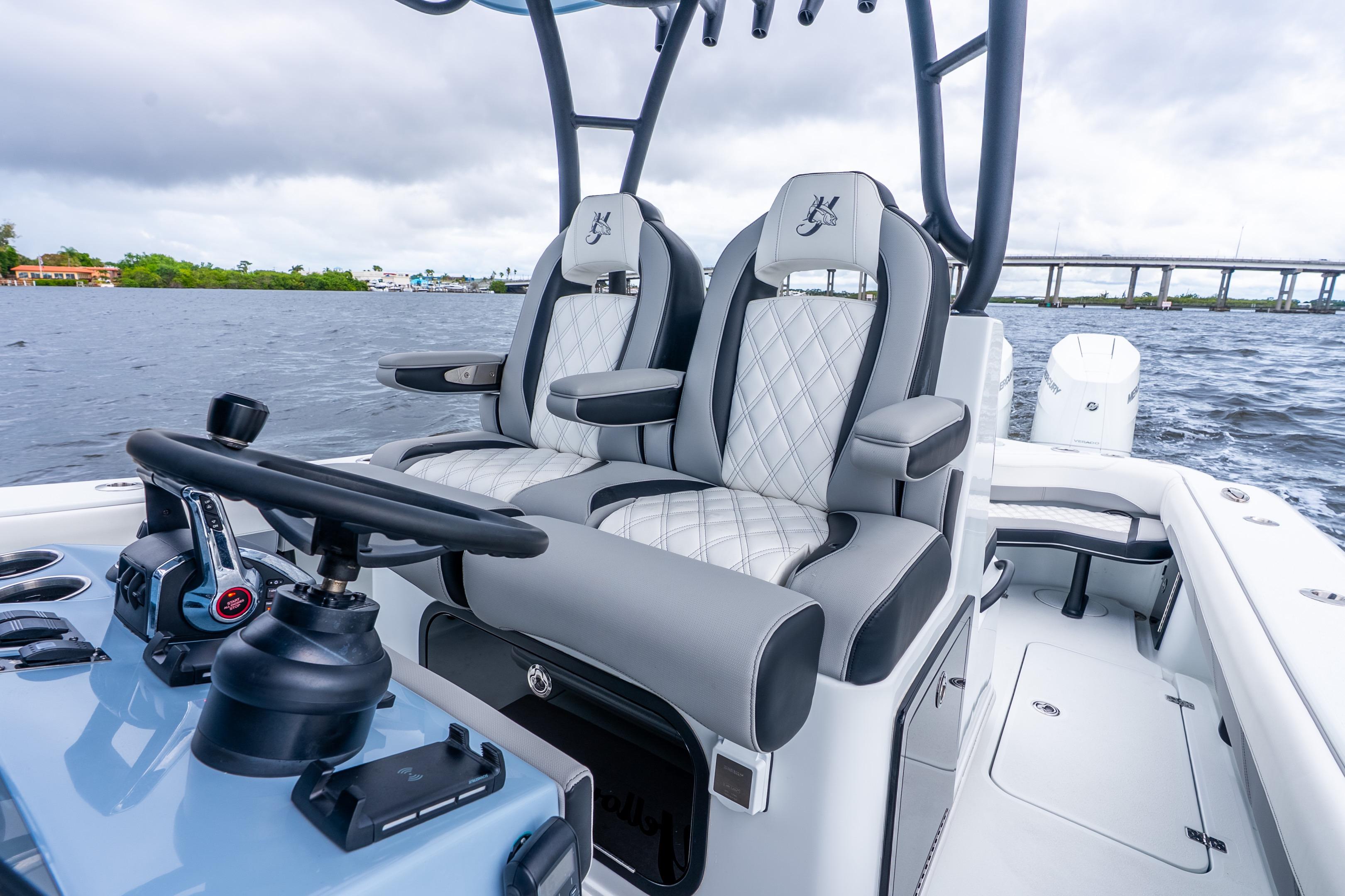 2025 Yellowfin 36 Offshore boat interior with luxury seating and steering wheel on open water.