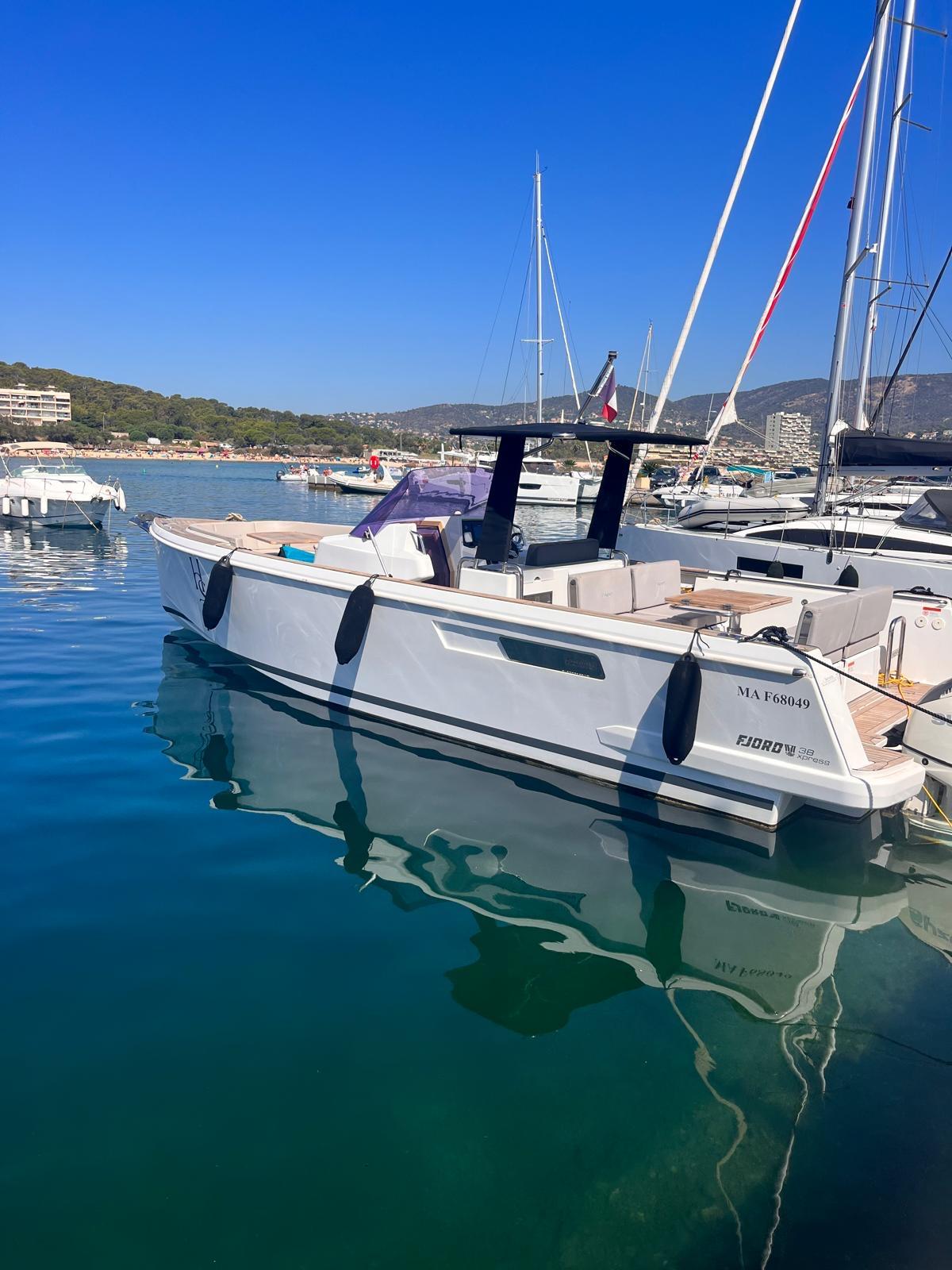 2017 Fjord 36 yacht docked in a marina under clear blue skies.