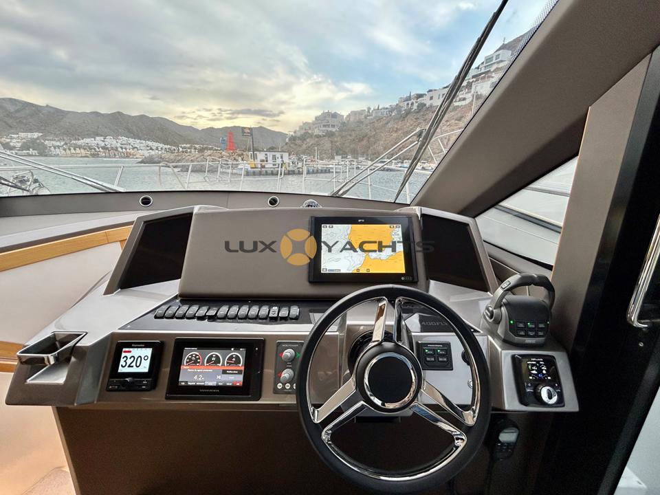 Cockpit view of 2021 Galeon 400 Fly yacht with modern navigation equipment.