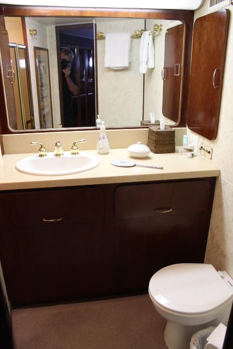 1985 Hatteras 58 Motor Yacht bathroom with sink, mirror, and toilet.