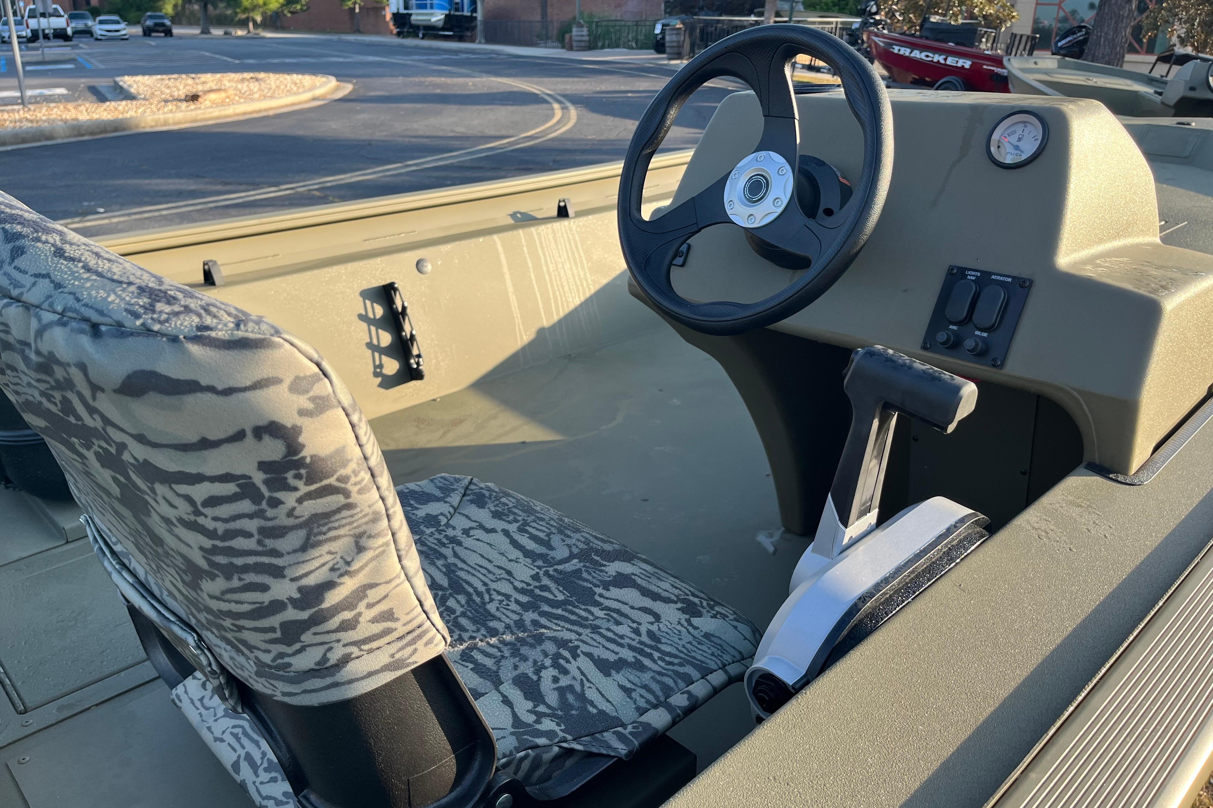 2026 Tracker Grizzly 1754 SC boat interior with steering wheel and camo seat.