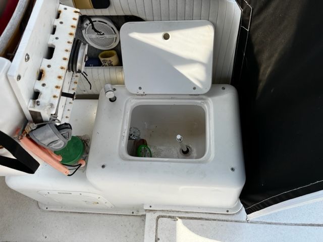 An open storage compartment on a 1998 Sport-Craft 252 Sport Fish boat.