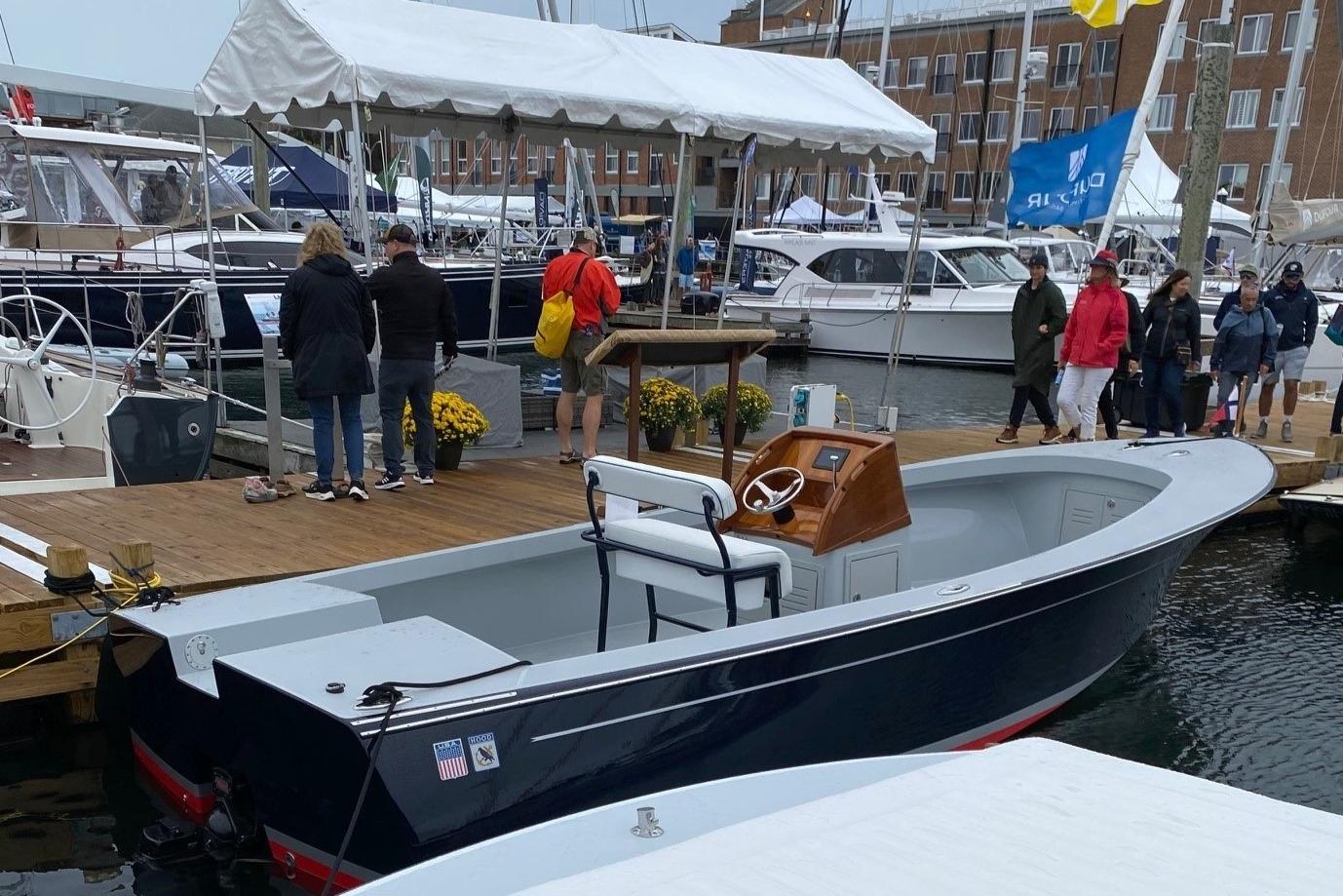 2024 C.W. Hood 26E Electric Runabout docked at a marina with people nearby.