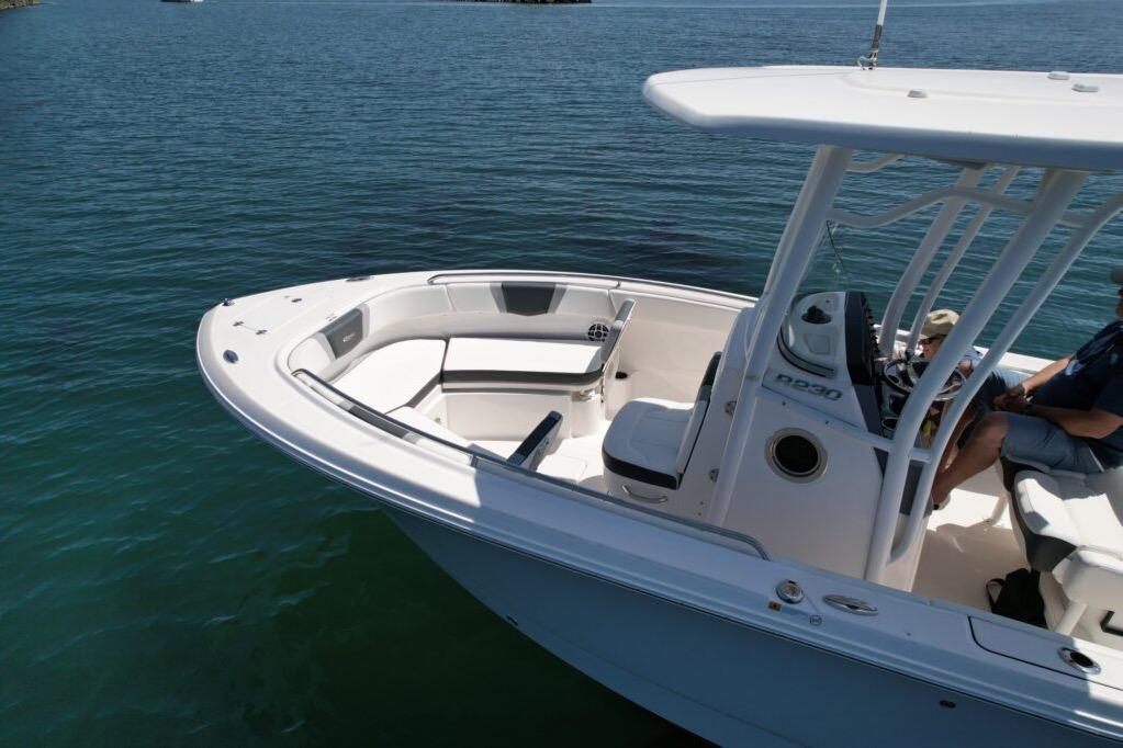2022 Robalo R230 Center Console boat on calm water, featuring spacious seating and sleek design.