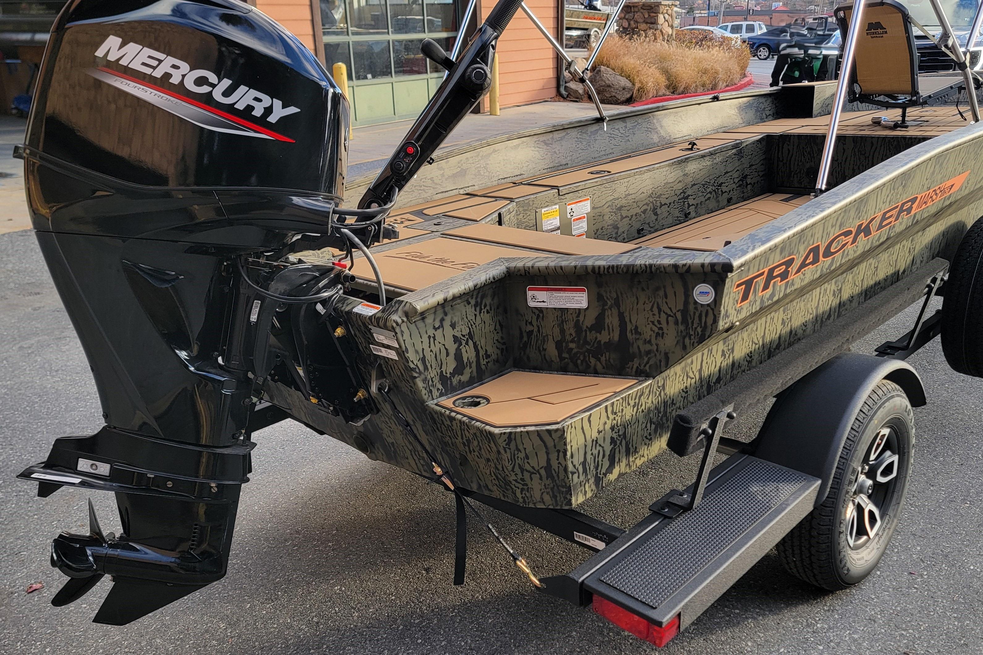 2026 Tracker Grizzly 1756 T Marsh boat with Mercury outboard motor, parked on trailer.