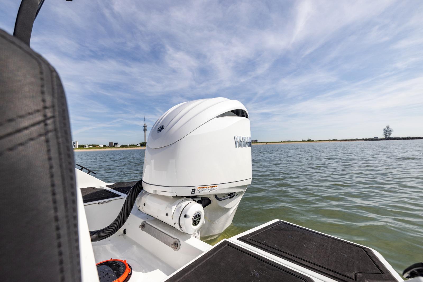 Boat with Yamaha outboard motor on water, clear sky, Iron 707, 2022 model.