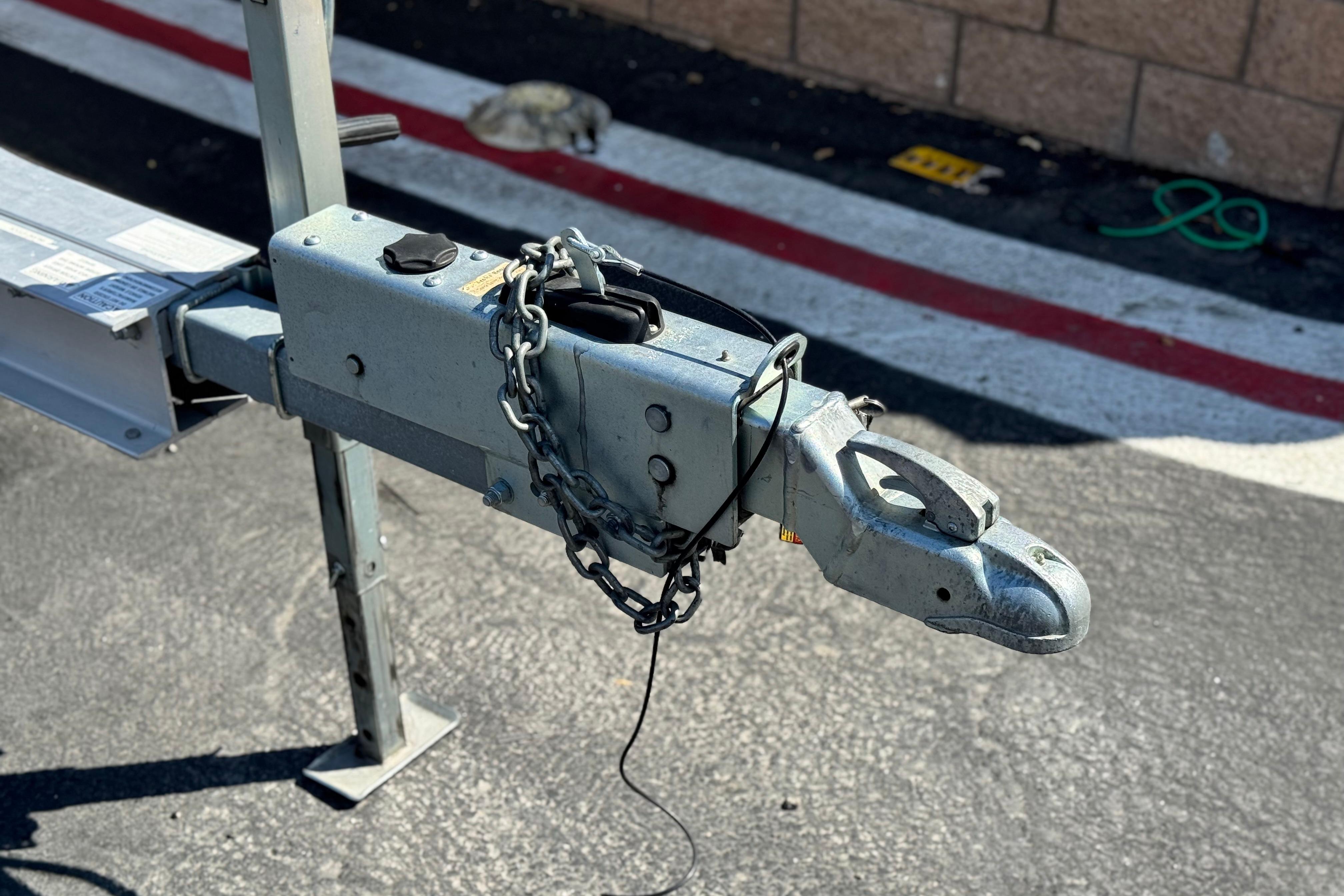 Trailer hitch of a 2008 Cobalt 262 boat, secured with a chain.